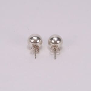 Silver stud earrings on white background.