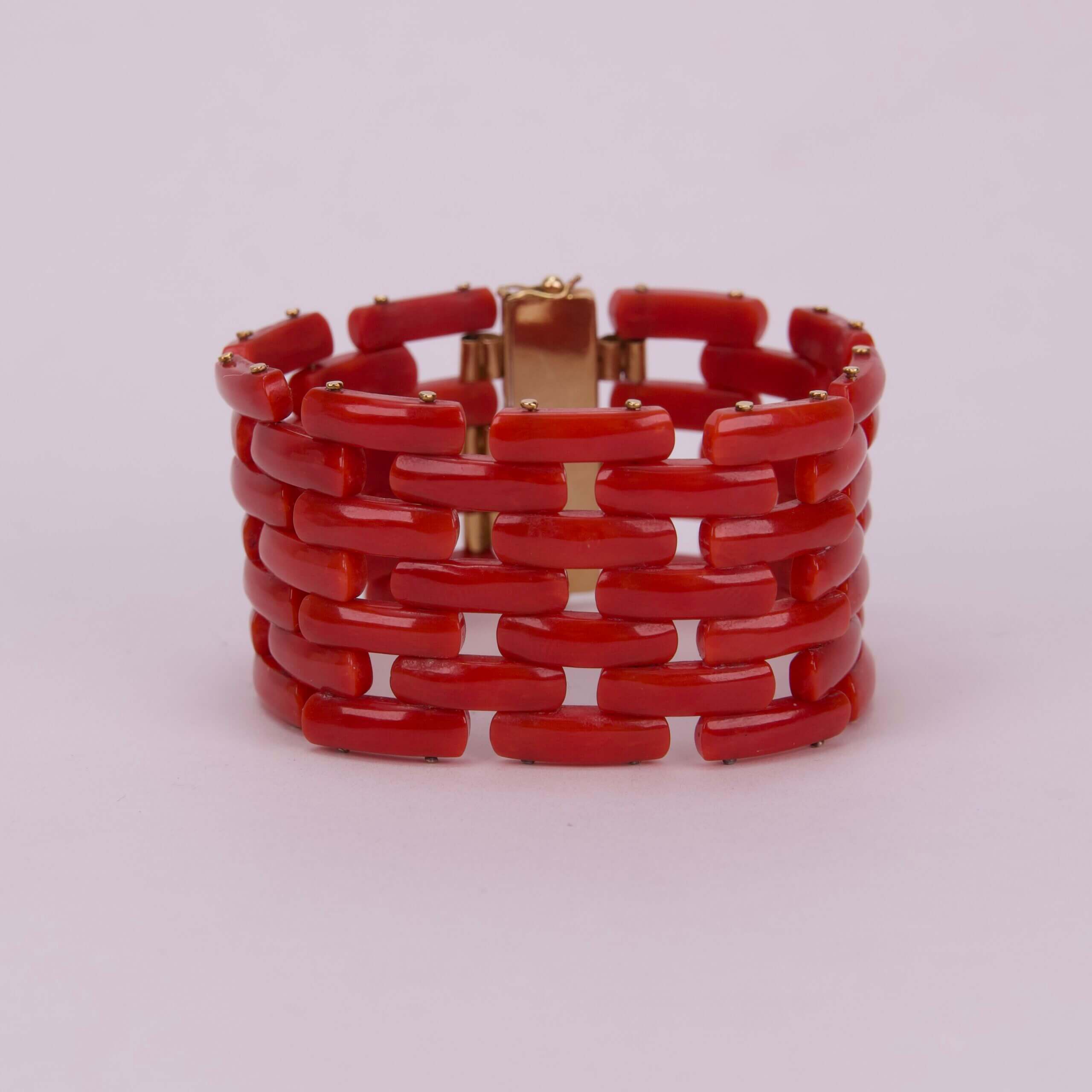 Red beaded bracelet with gold clasp.