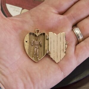 Heart-shaped locket with hidden skeleton inside.