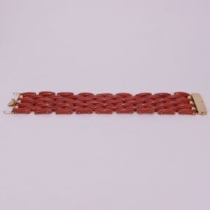 Red link bracelet on light background.