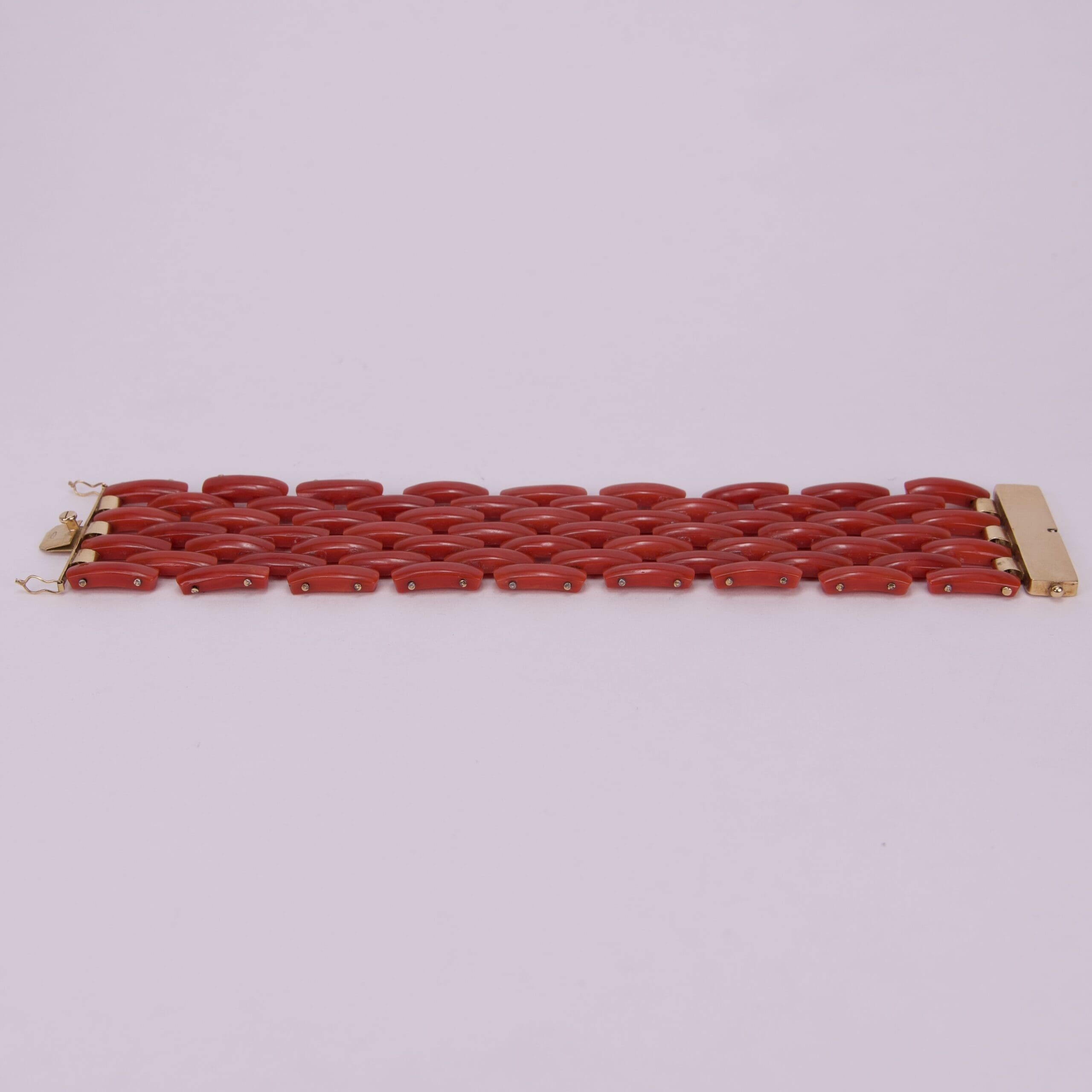 Red link bracelet on light background.
