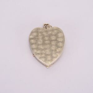 Gold heart-shaped locket on white background.