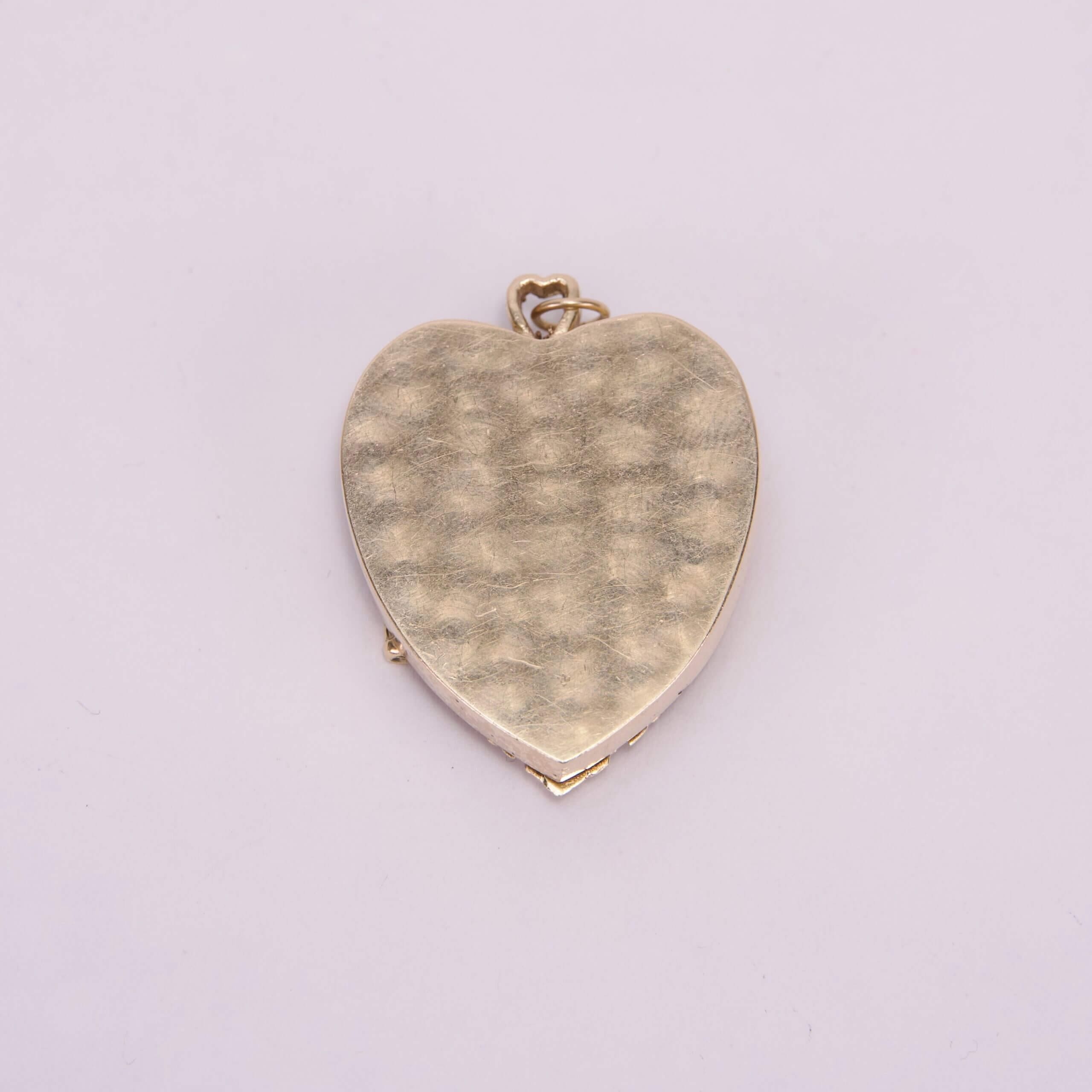 Gold heart-shaped locket on white background.