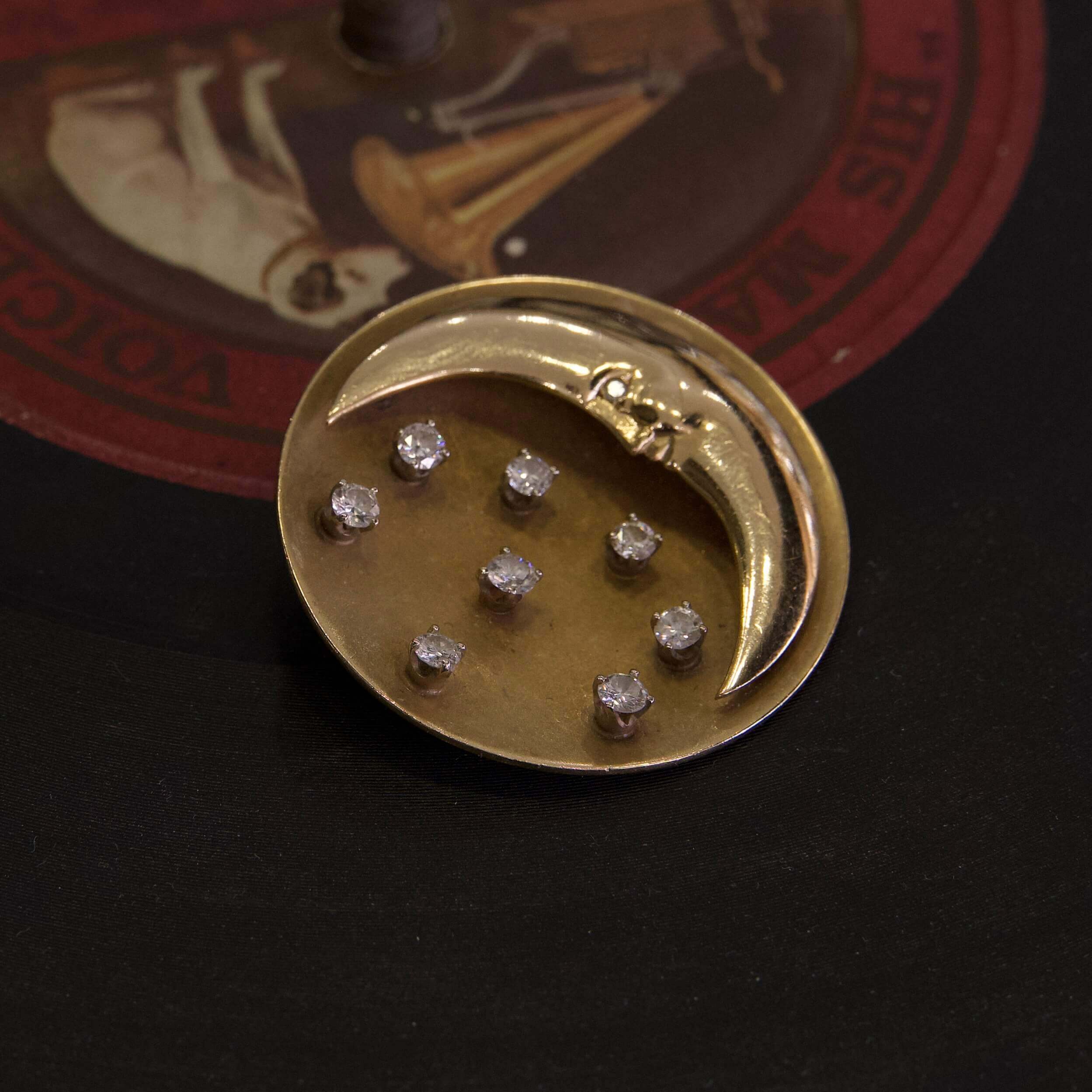 Gold moon brooch with diamond stars.