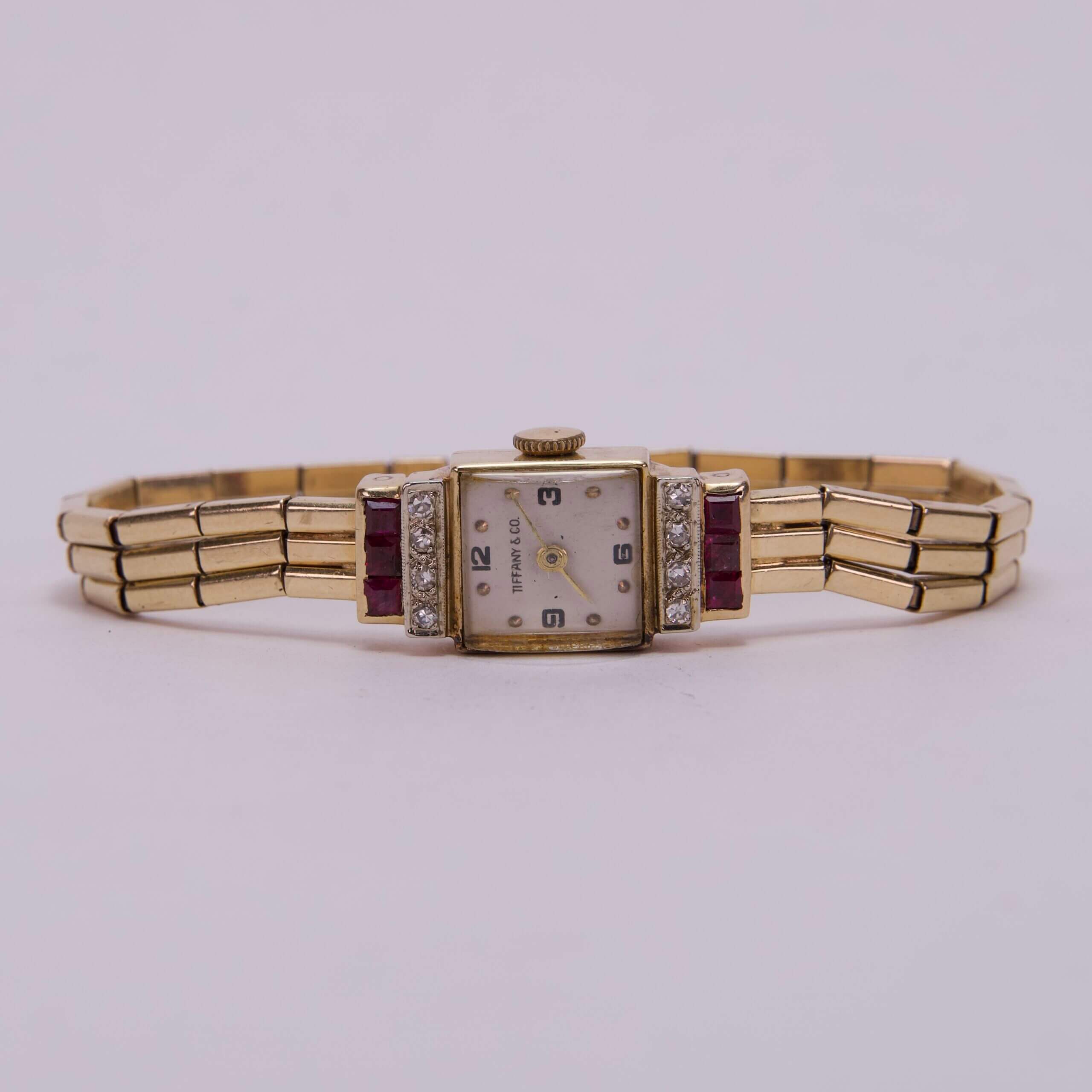 Gold vintage wristwatch with ruby accents.