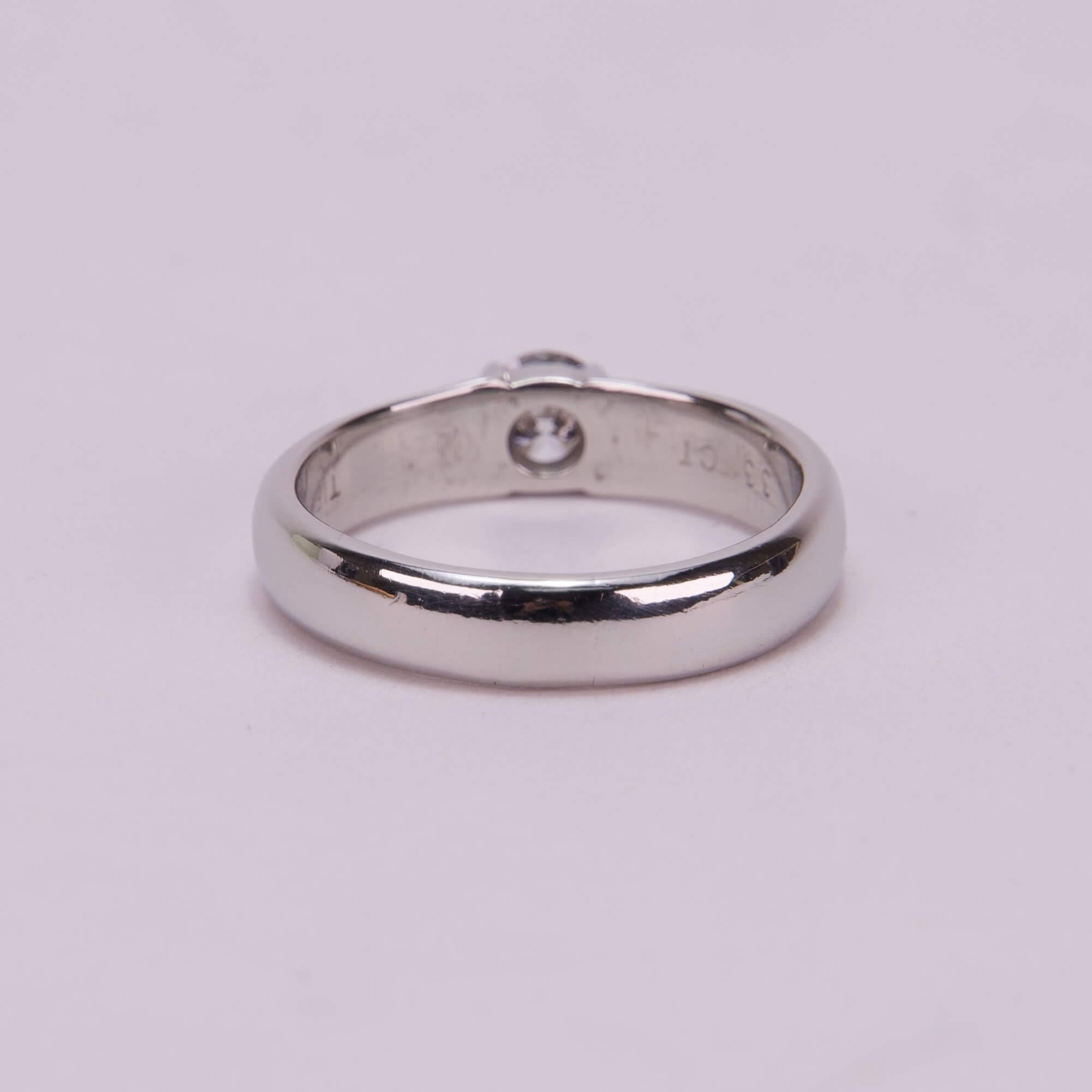 Silver ring with a single diamond.