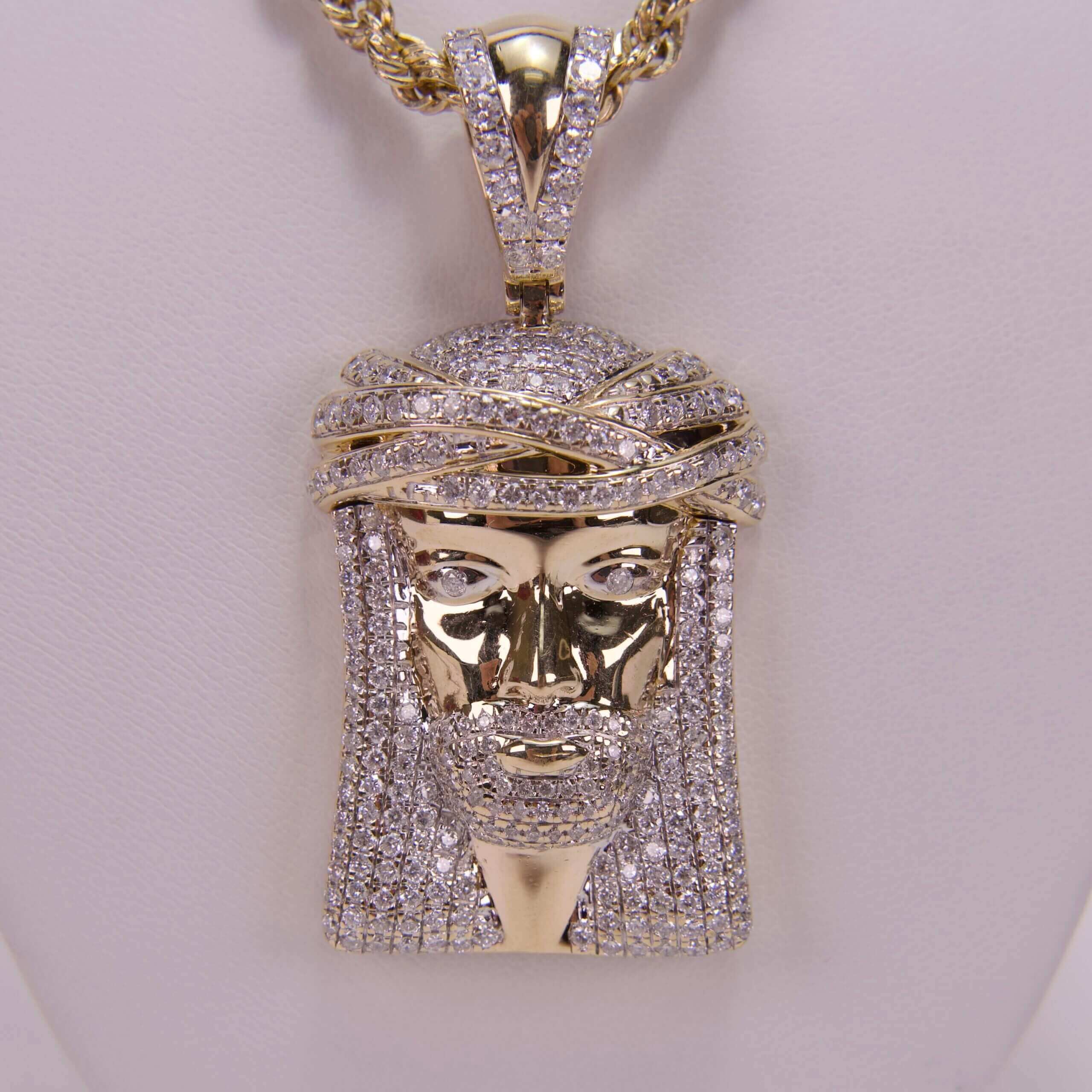 Gold diamond Jesus pendant necklace on display.