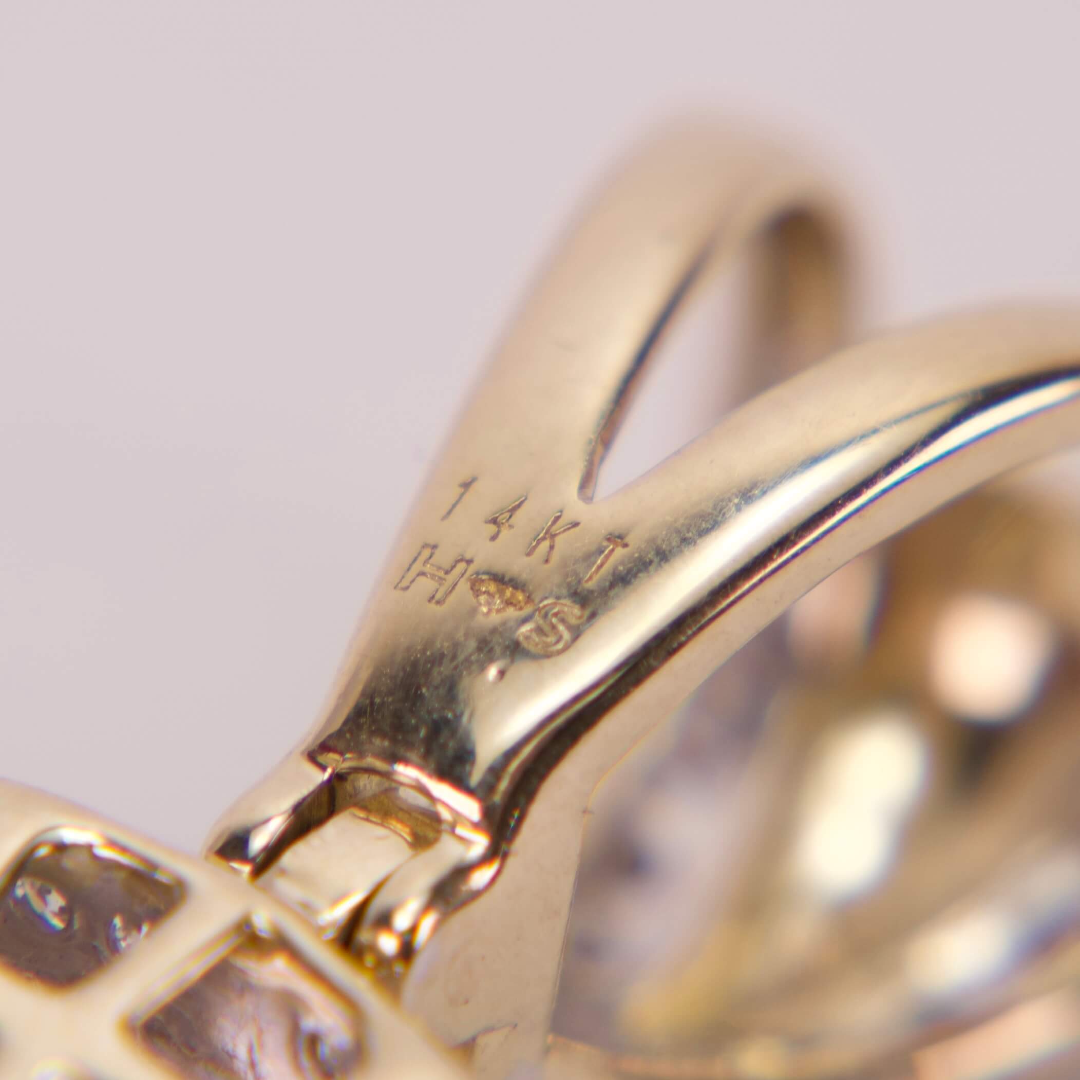 Close-up of 14k gold jewelry hallmark.