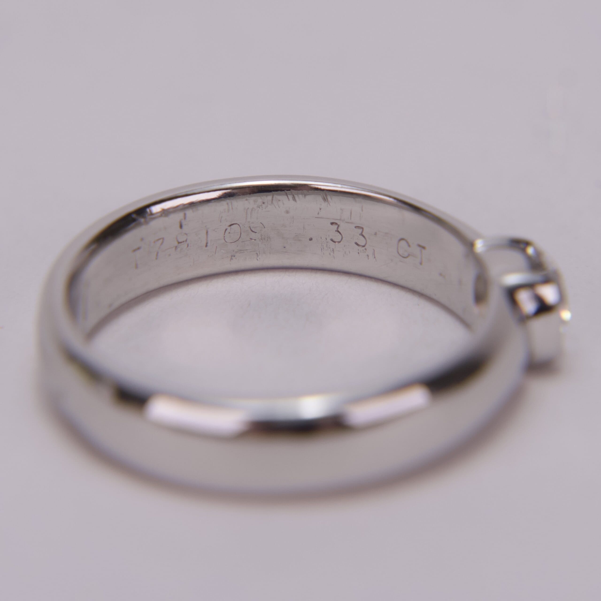 Silver ring with engraved inscription inside.