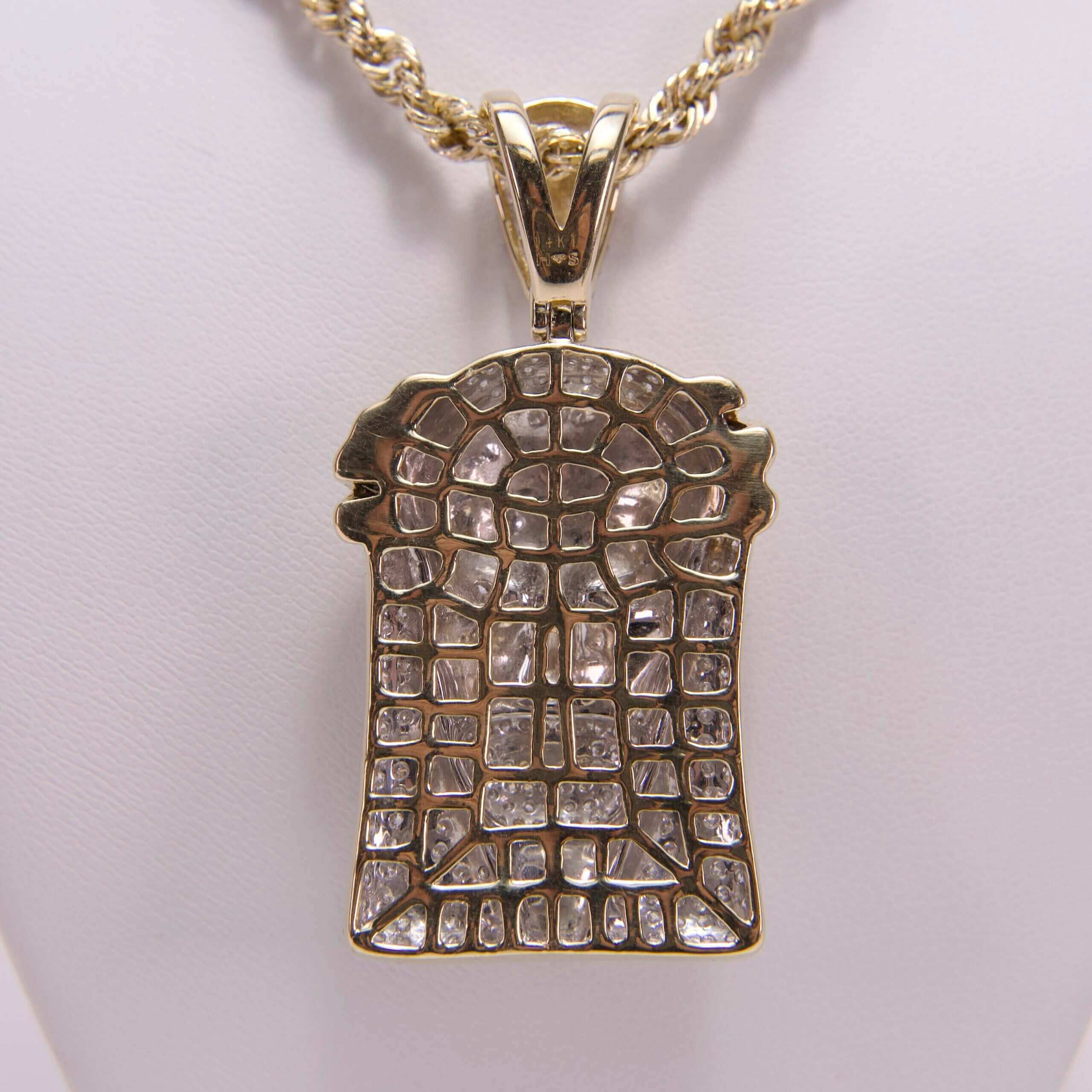 Gold pendant with intricate diamond pattern.
