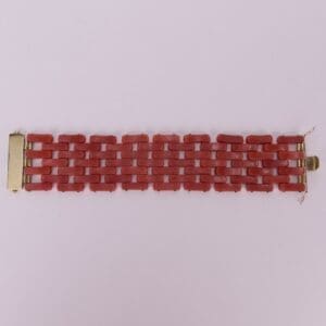 Red link bracelet with gold clasps.