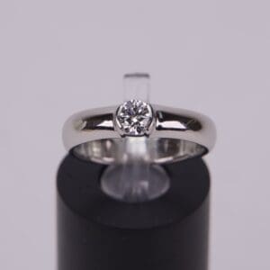 Silver ring with a central diamond.