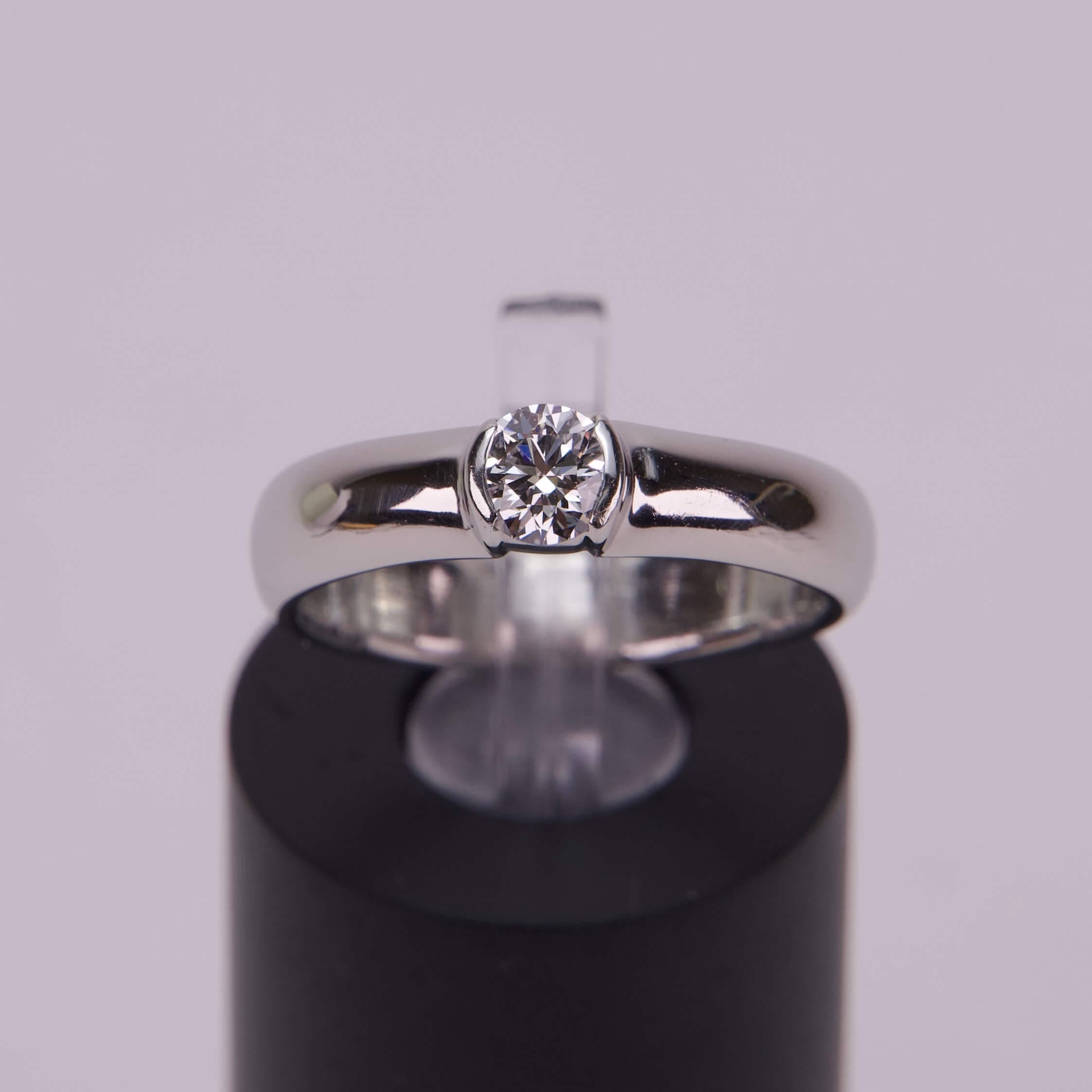 Silver ring with a central diamond.