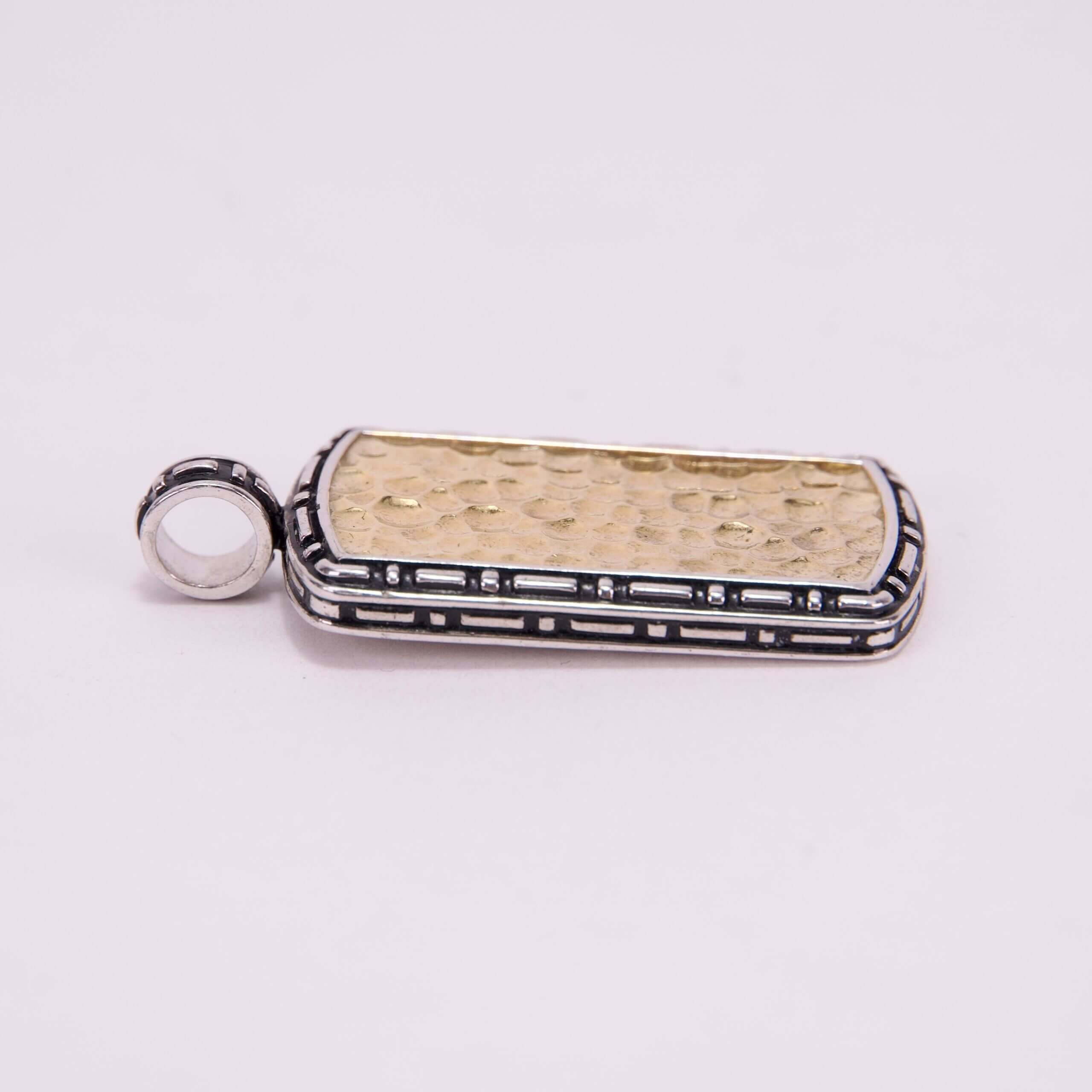 Gold rectangular pendant with silver border.