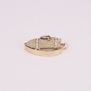 Gold shield-shaped pendant on white background.