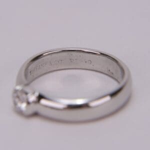 Platinum diamond ring on soft background.