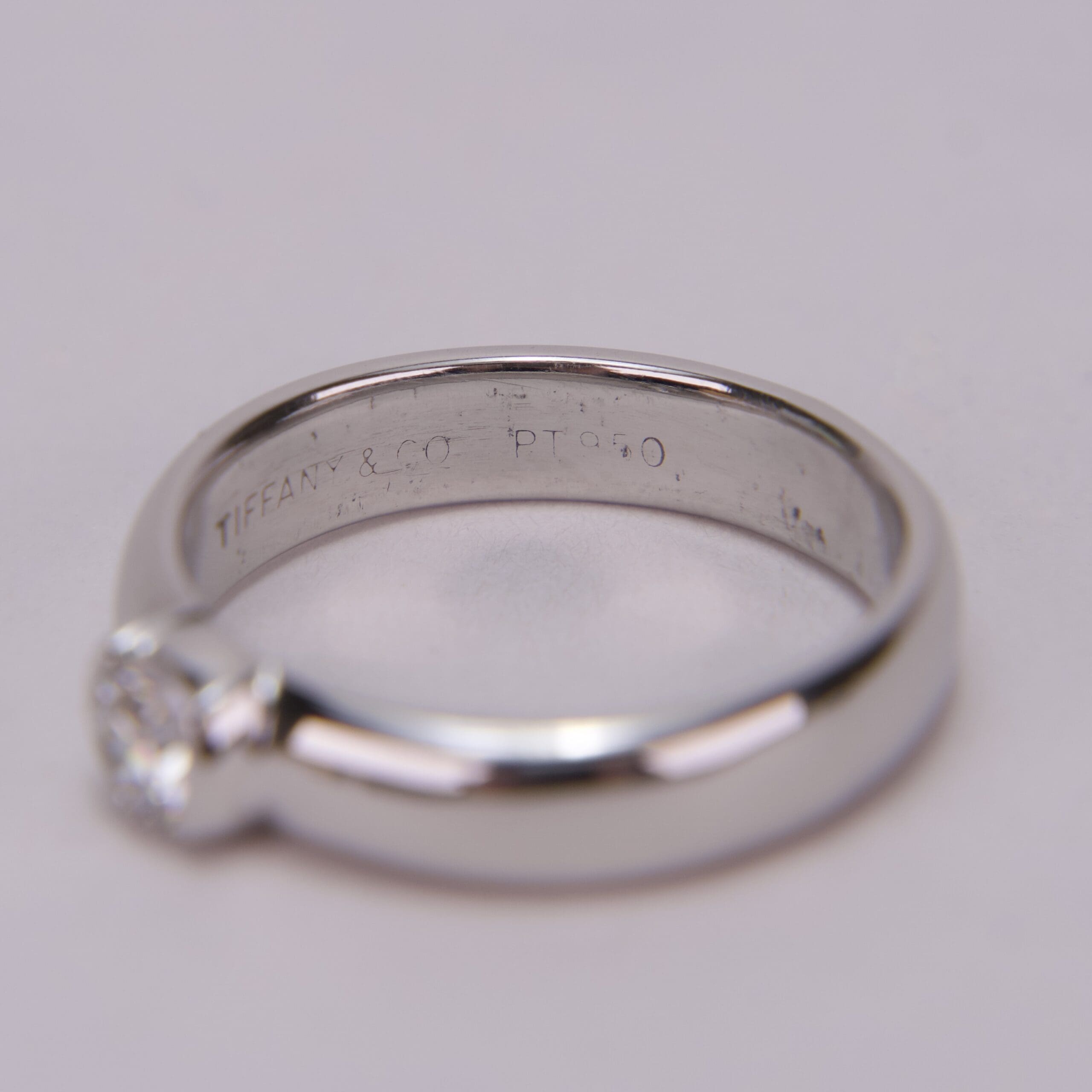Platinum diamond ring on soft background.