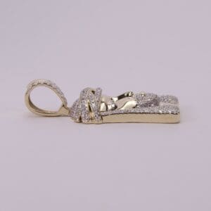 Gold and diamond encrusted pendant, side view.