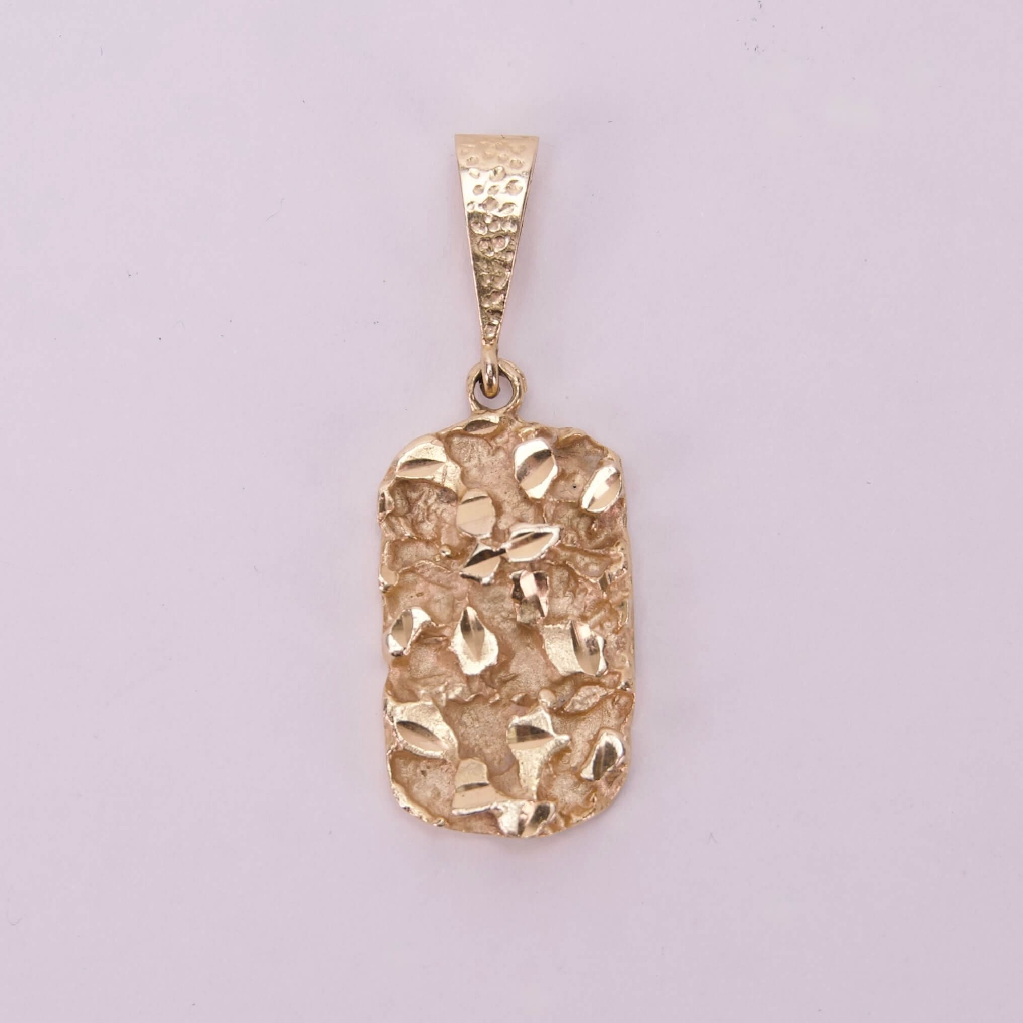 Gold textured pendant on plain background.