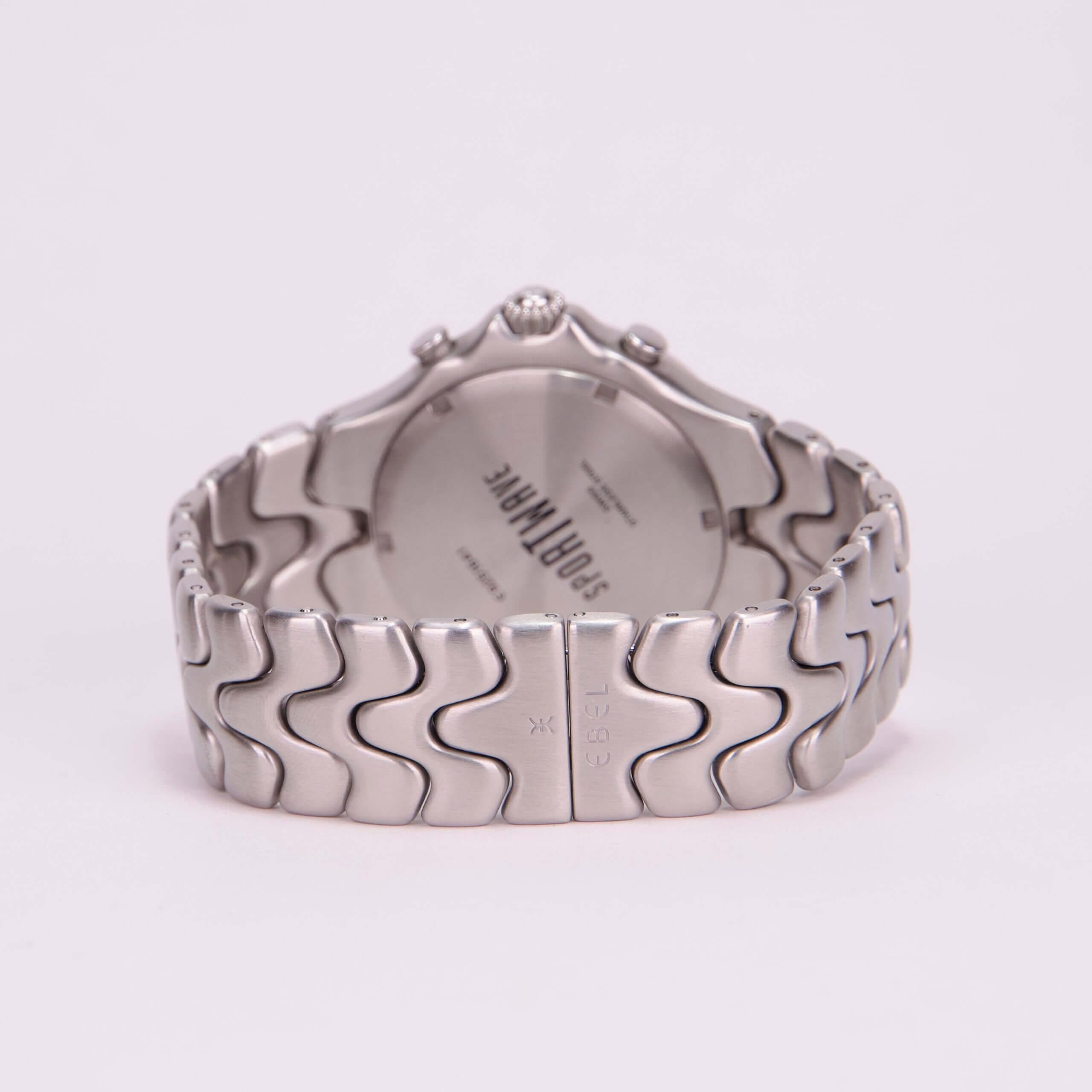 Silver watch with wavy link bracelet.