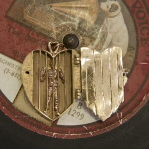 Heart-shaped locket on vintage record.