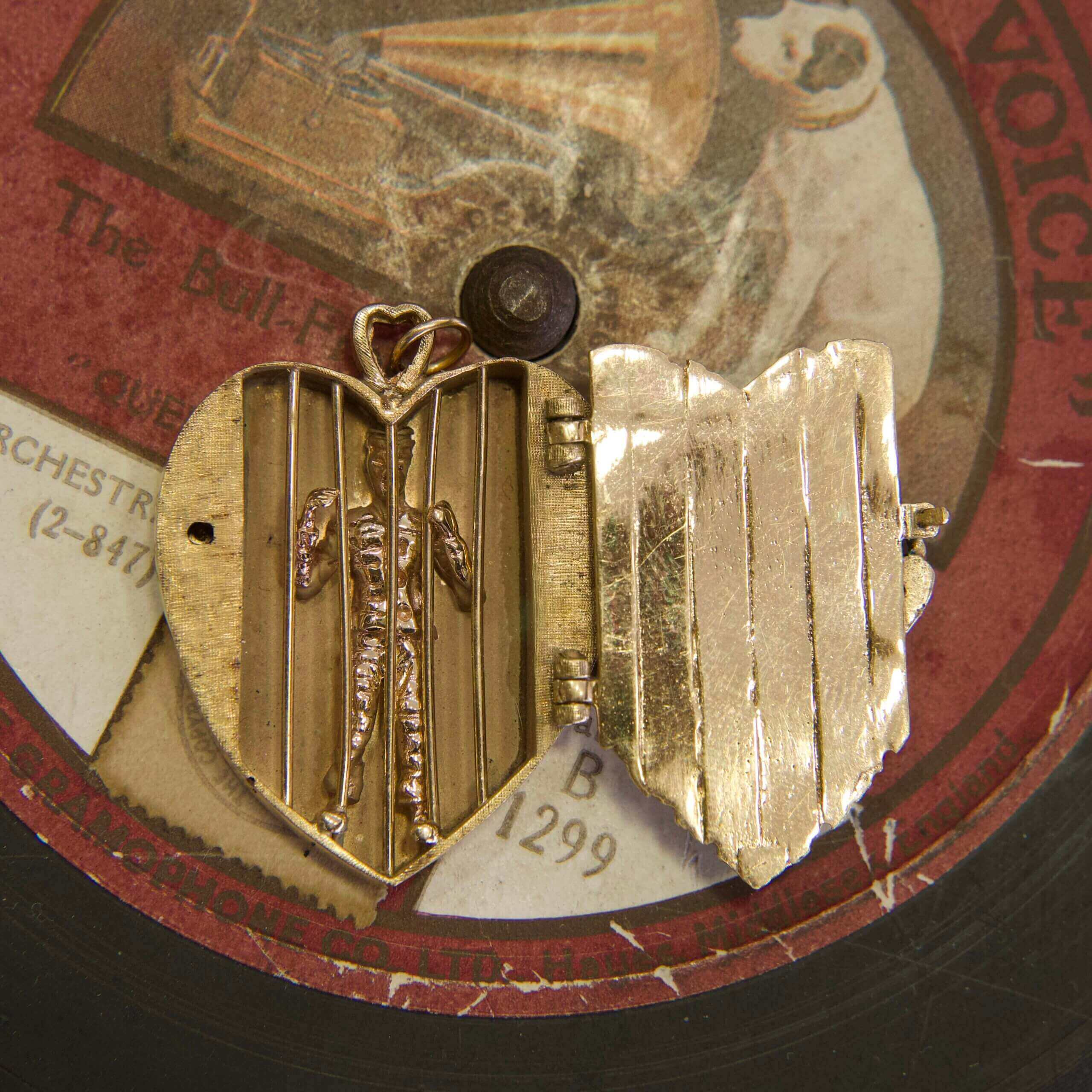 Heart-shaped locket on vintage record.