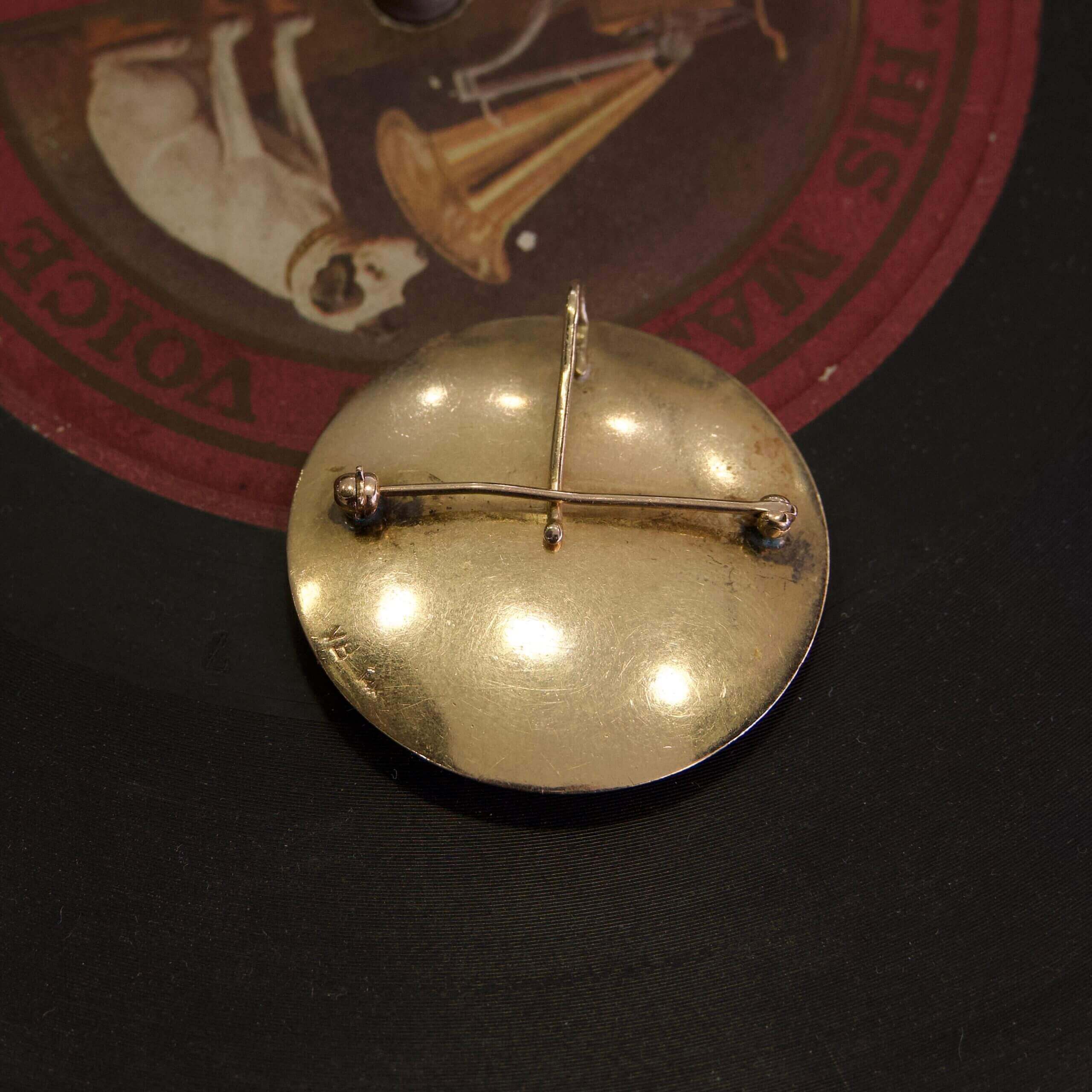 Gold brooch on vintage record label.
