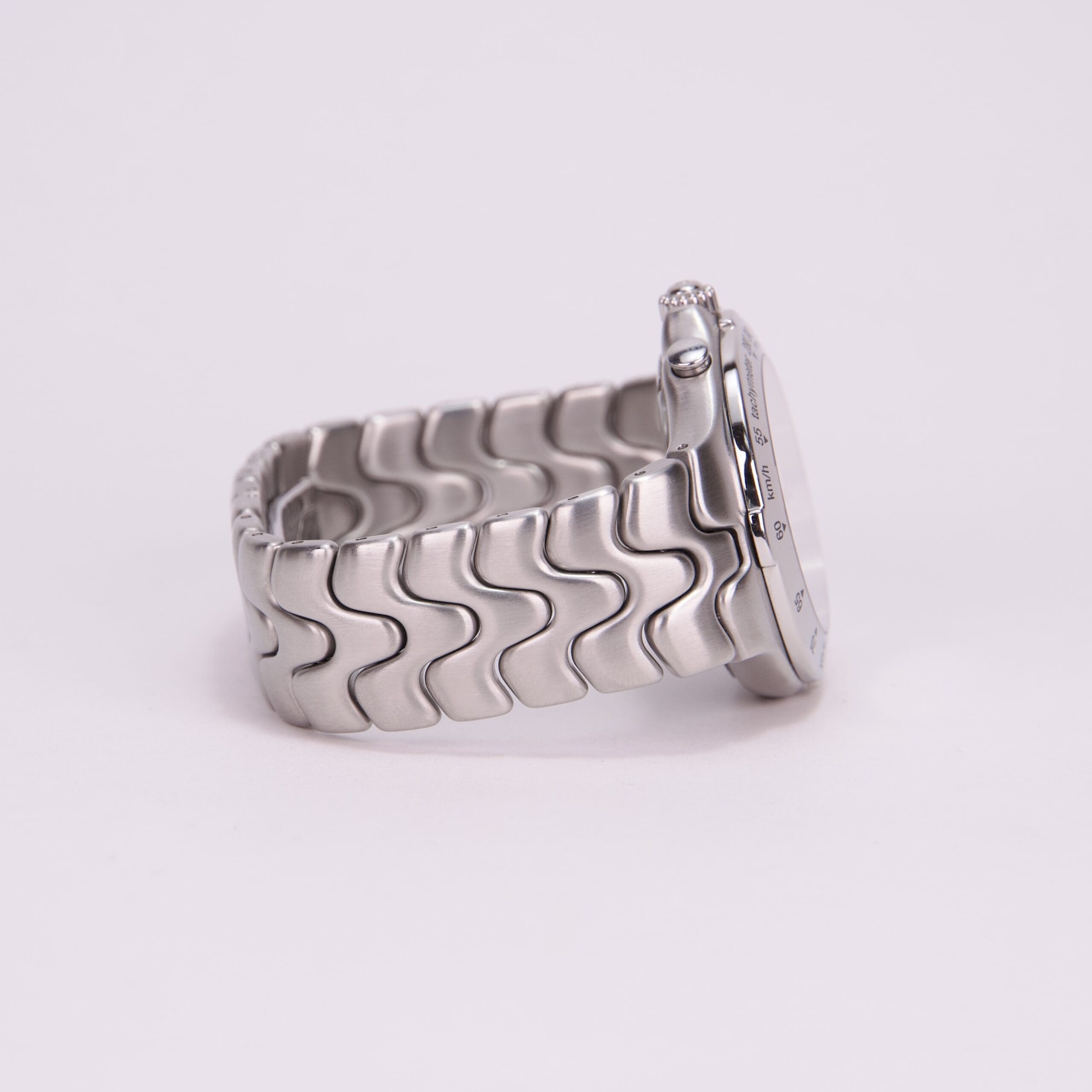 Silver watch with a wavy-patterned band.
