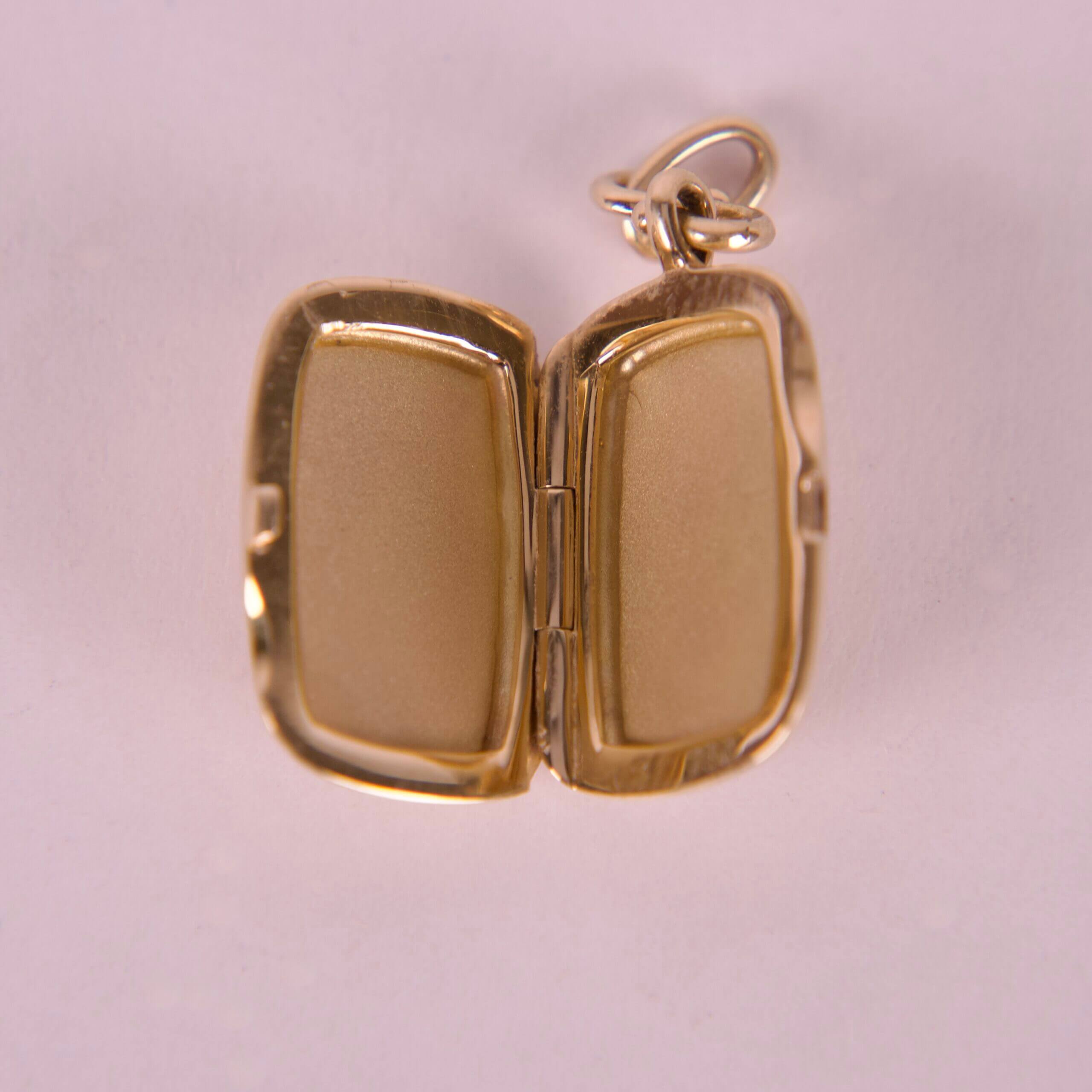 Open gold locket on a white background.