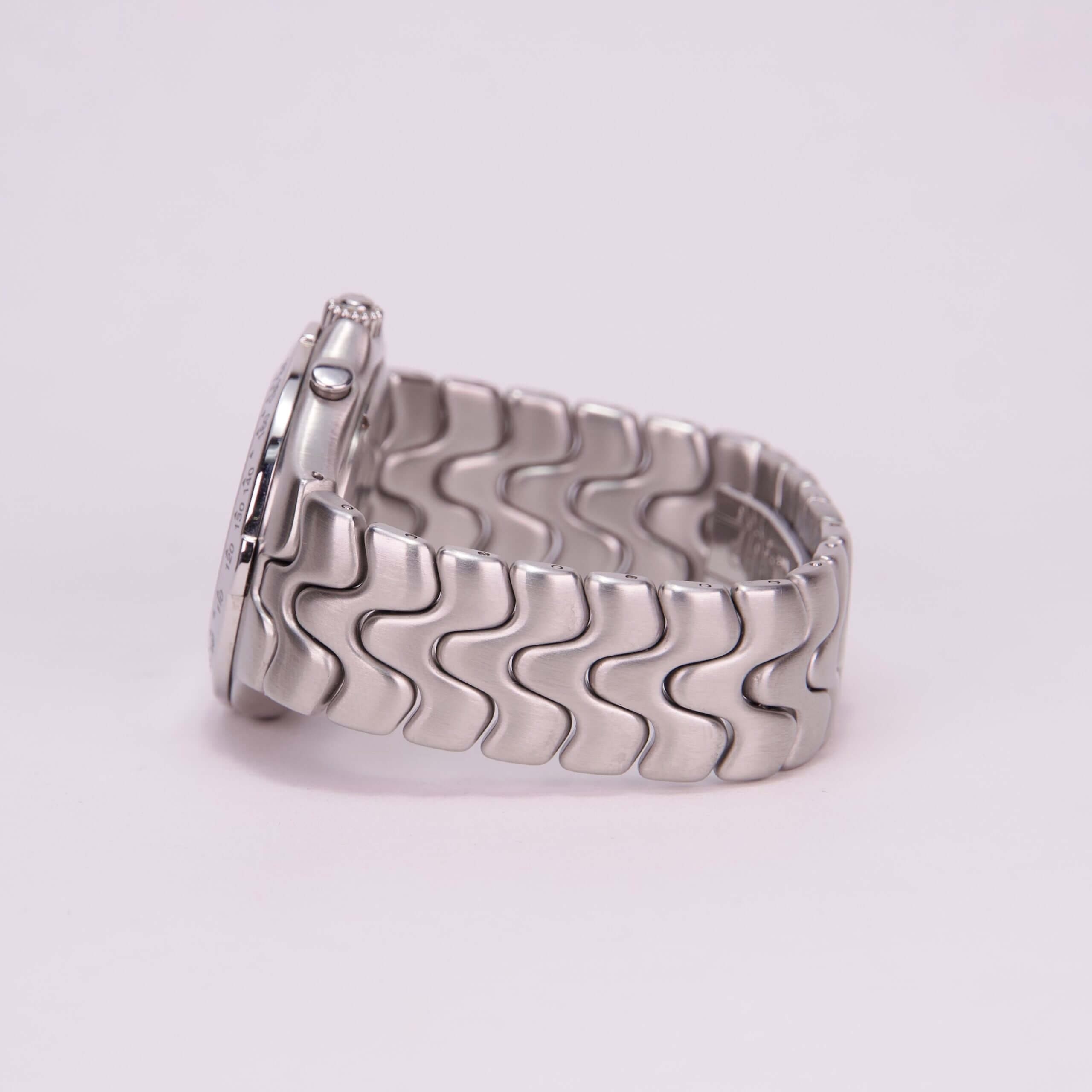 Silver watch with wavy link bracelet.