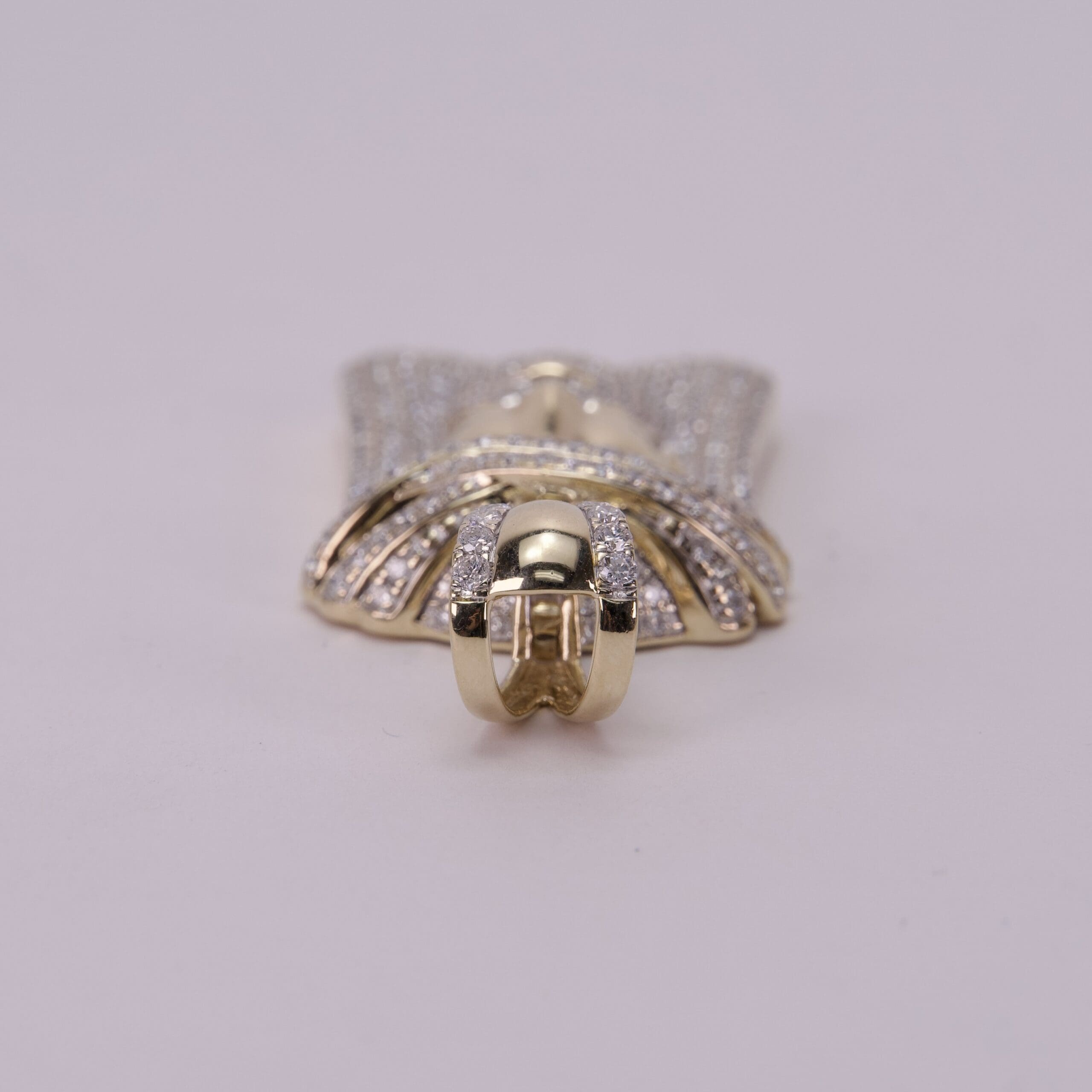 Gold and diamond encrusted pendant on display.