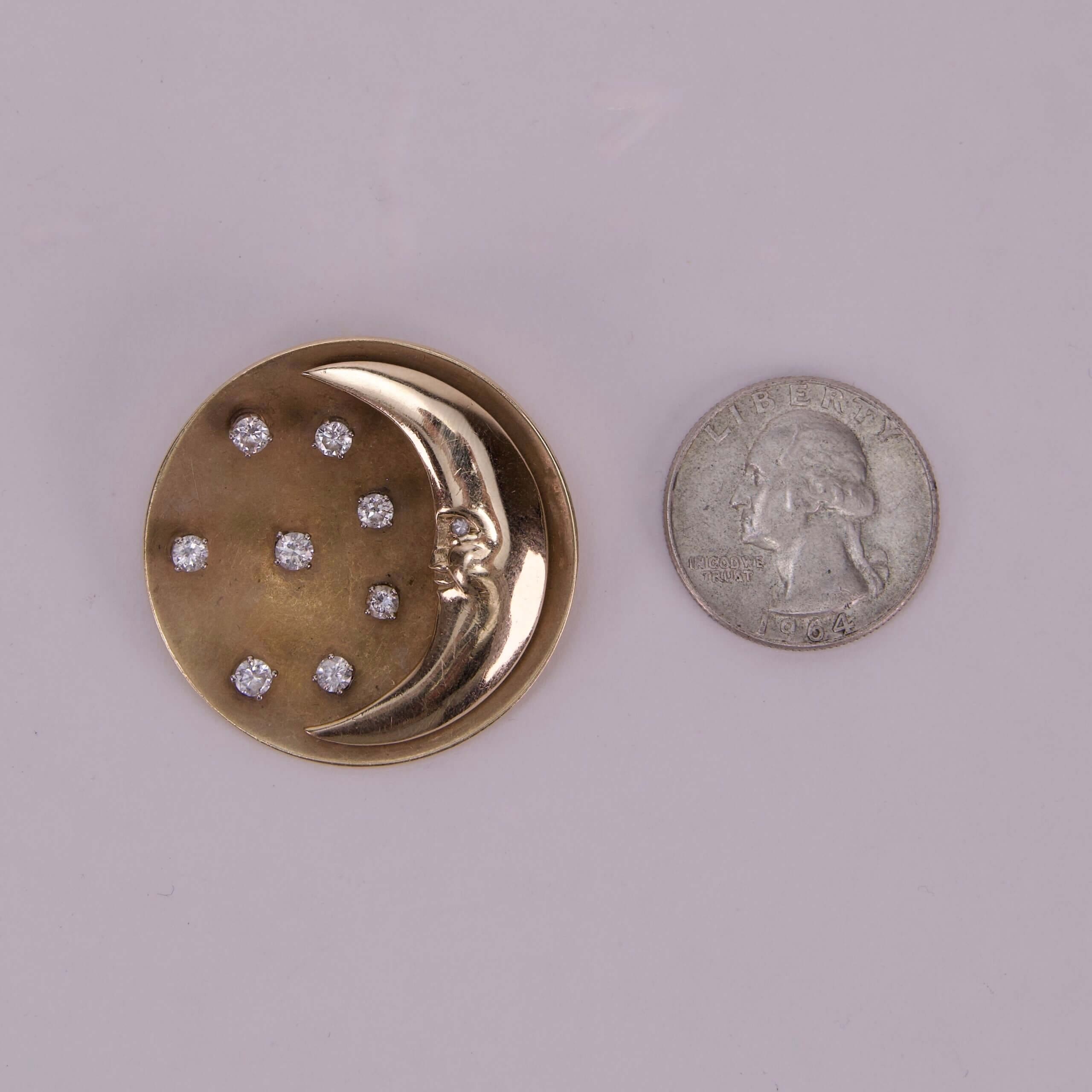 Gold moon pin with diamonds, quarter comparison.