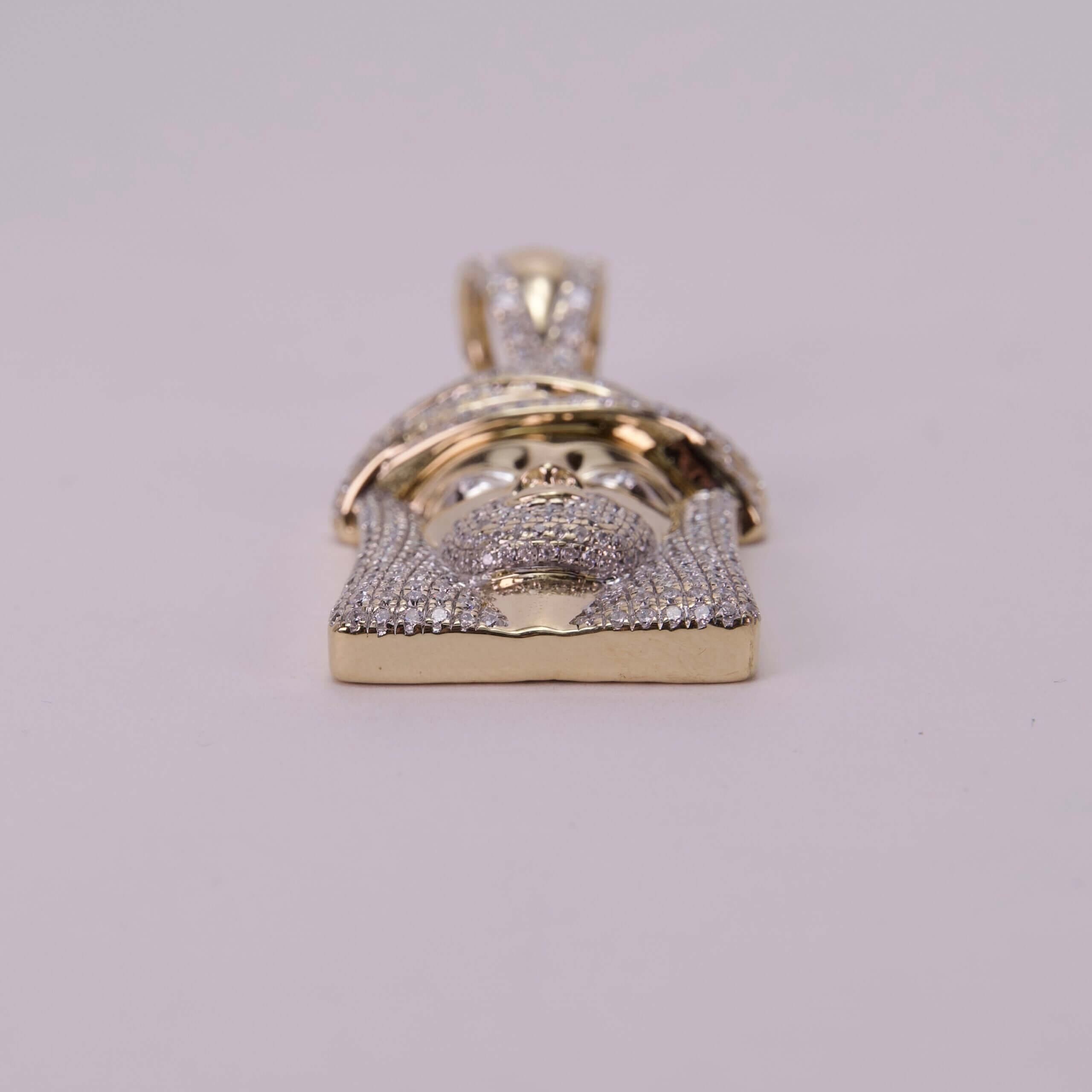 Gold Jesus face pendant with diamonds.