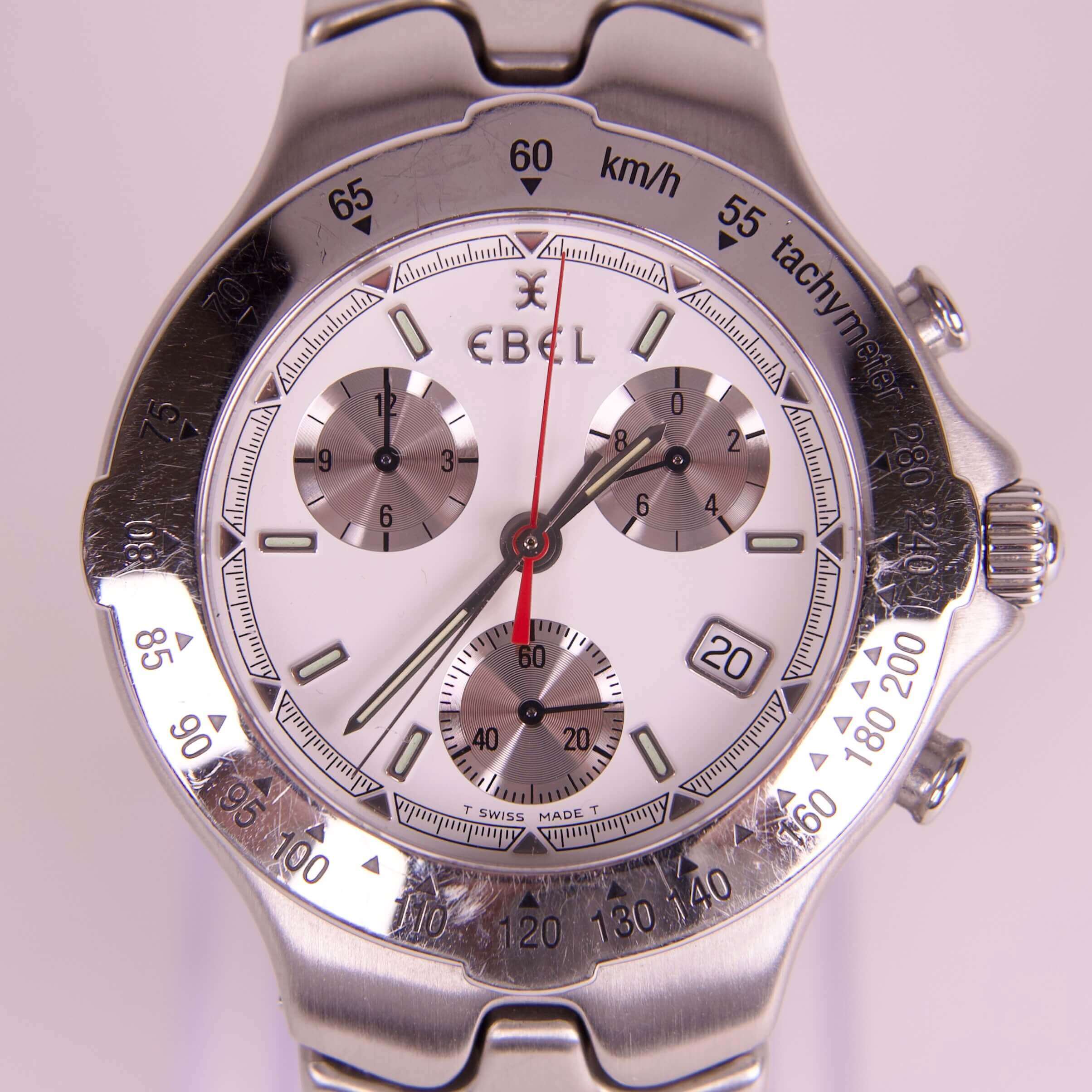 Silver chronograph watch with tachymeter bezel.