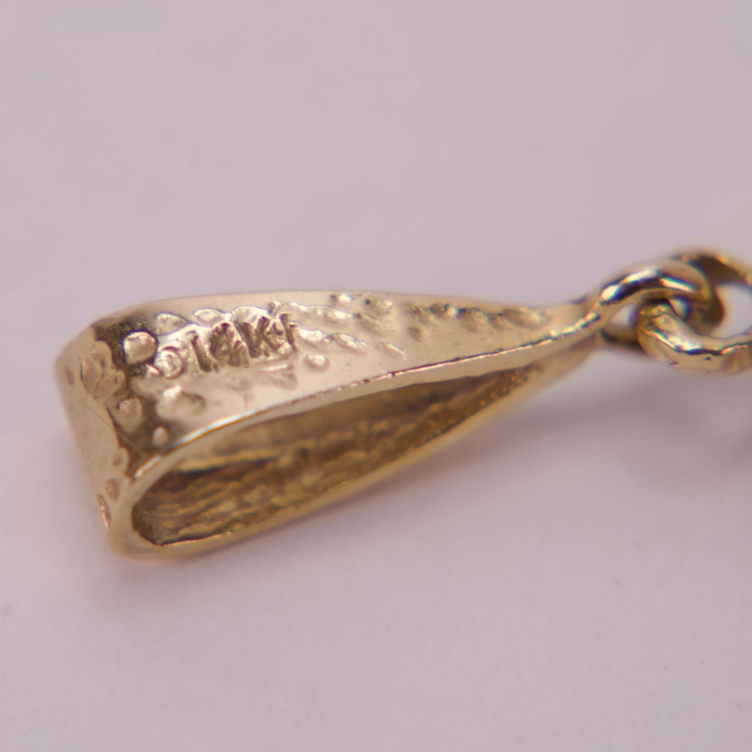 Close-up of a gold jewelry clasp.