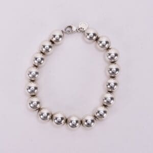 Silver bead bracelet on white background.