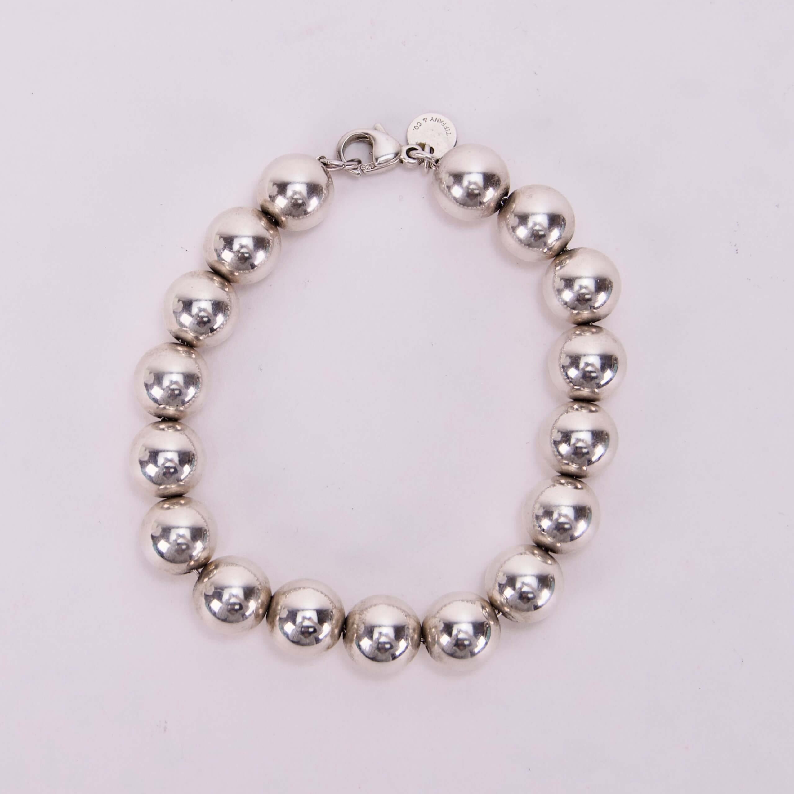 Silver bead bracelet on white background.