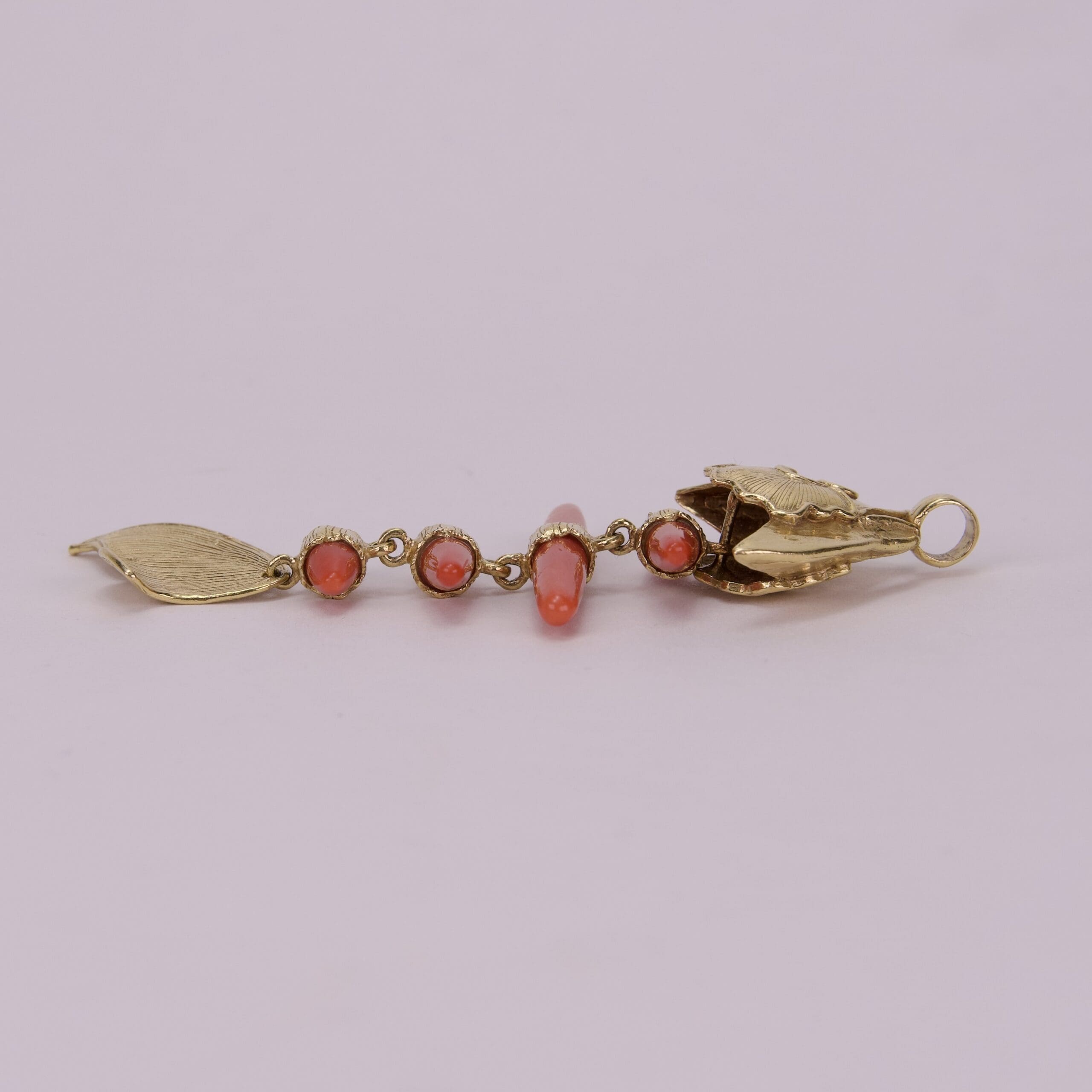Gold and coral beaded jewelry piece.