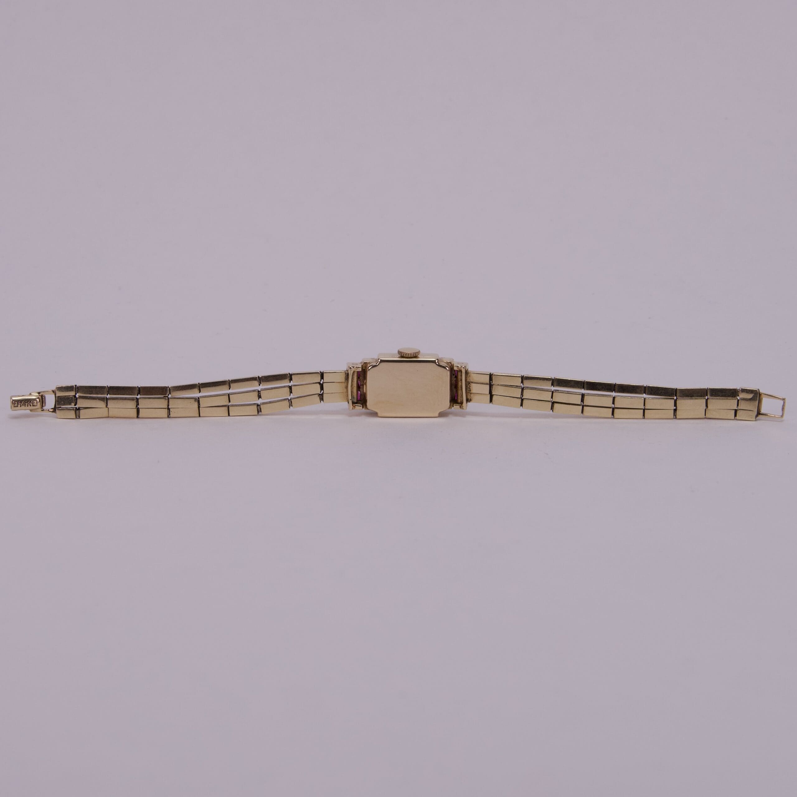 Gold wristwatch with metal strap.
