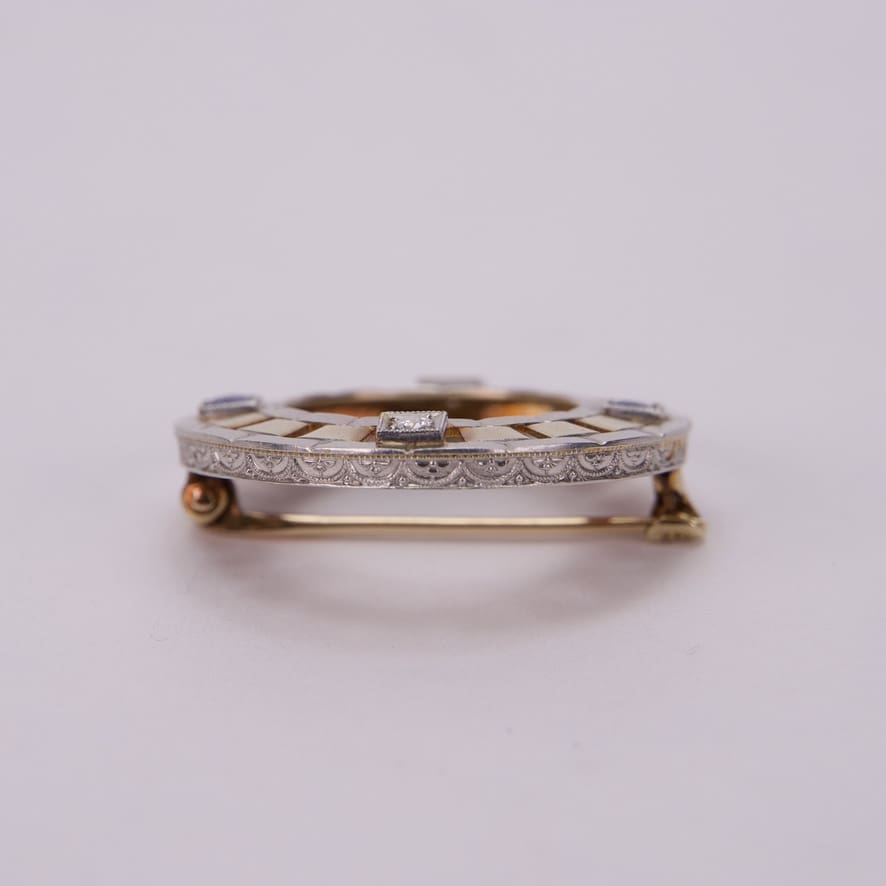 Ornate brooch with intricate geometric design.