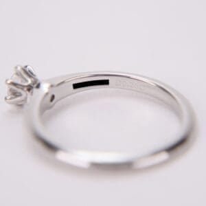Silver ring with diamond and engraved details.