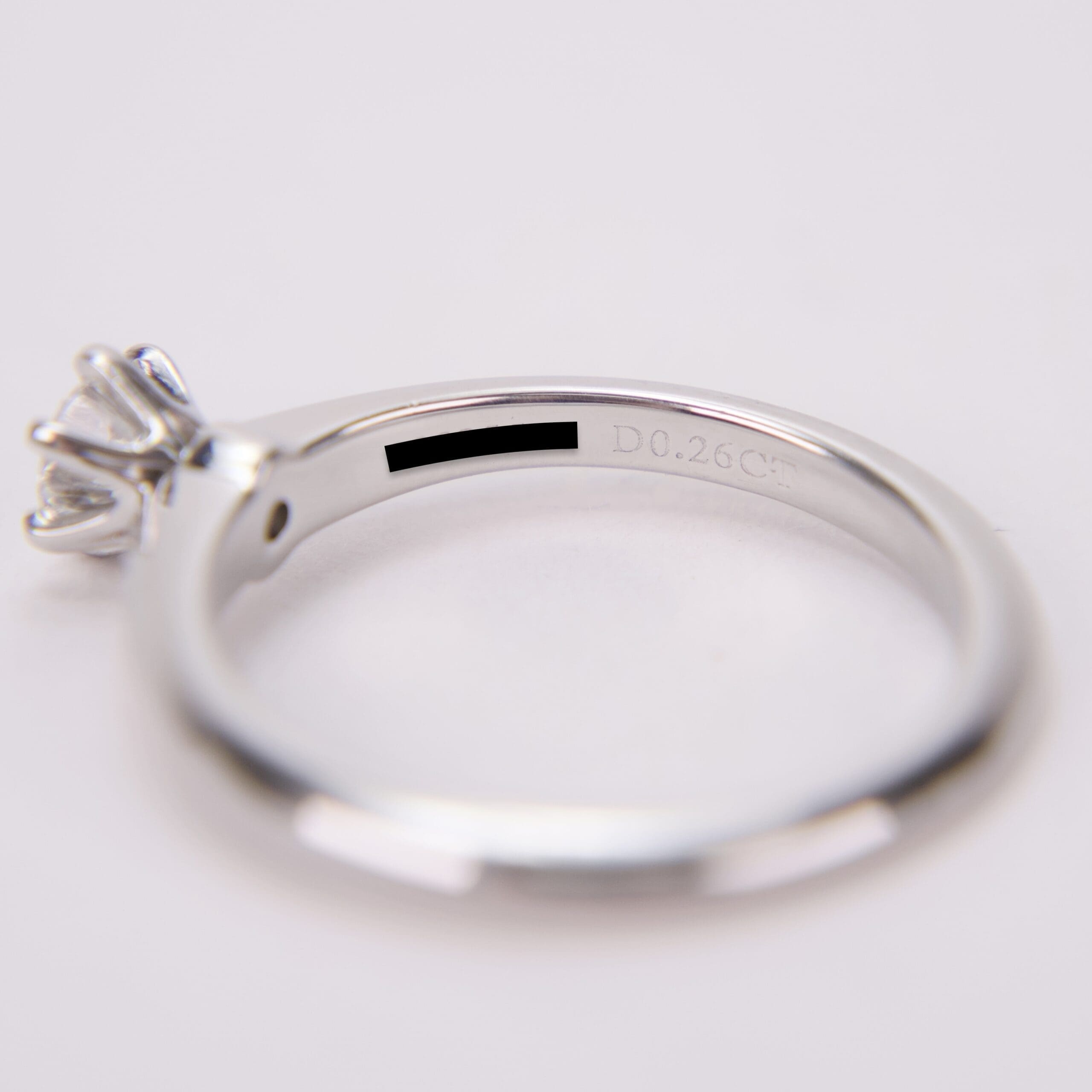 Silver ring with diamond and engraved details.