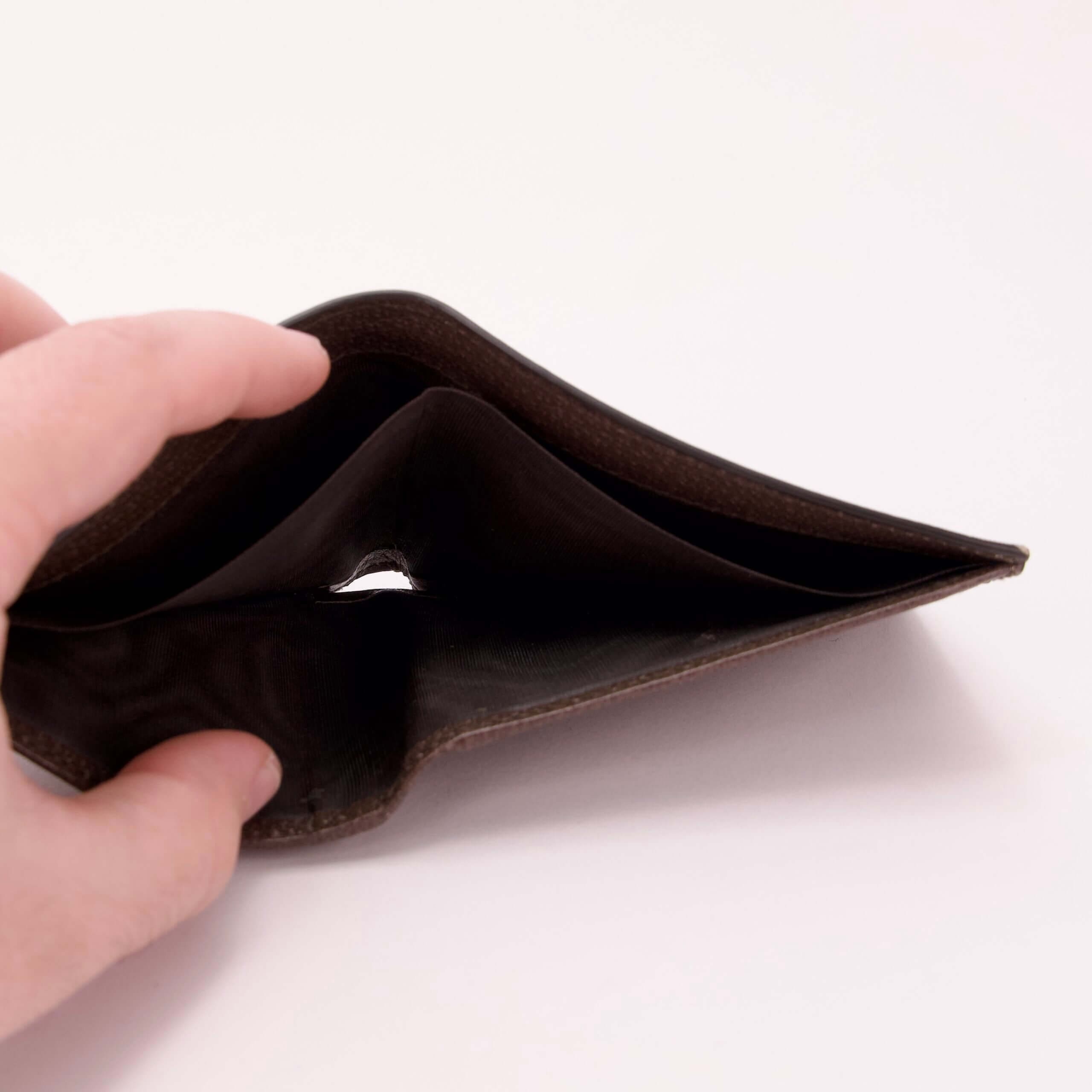 Empty wallet held open by hand.