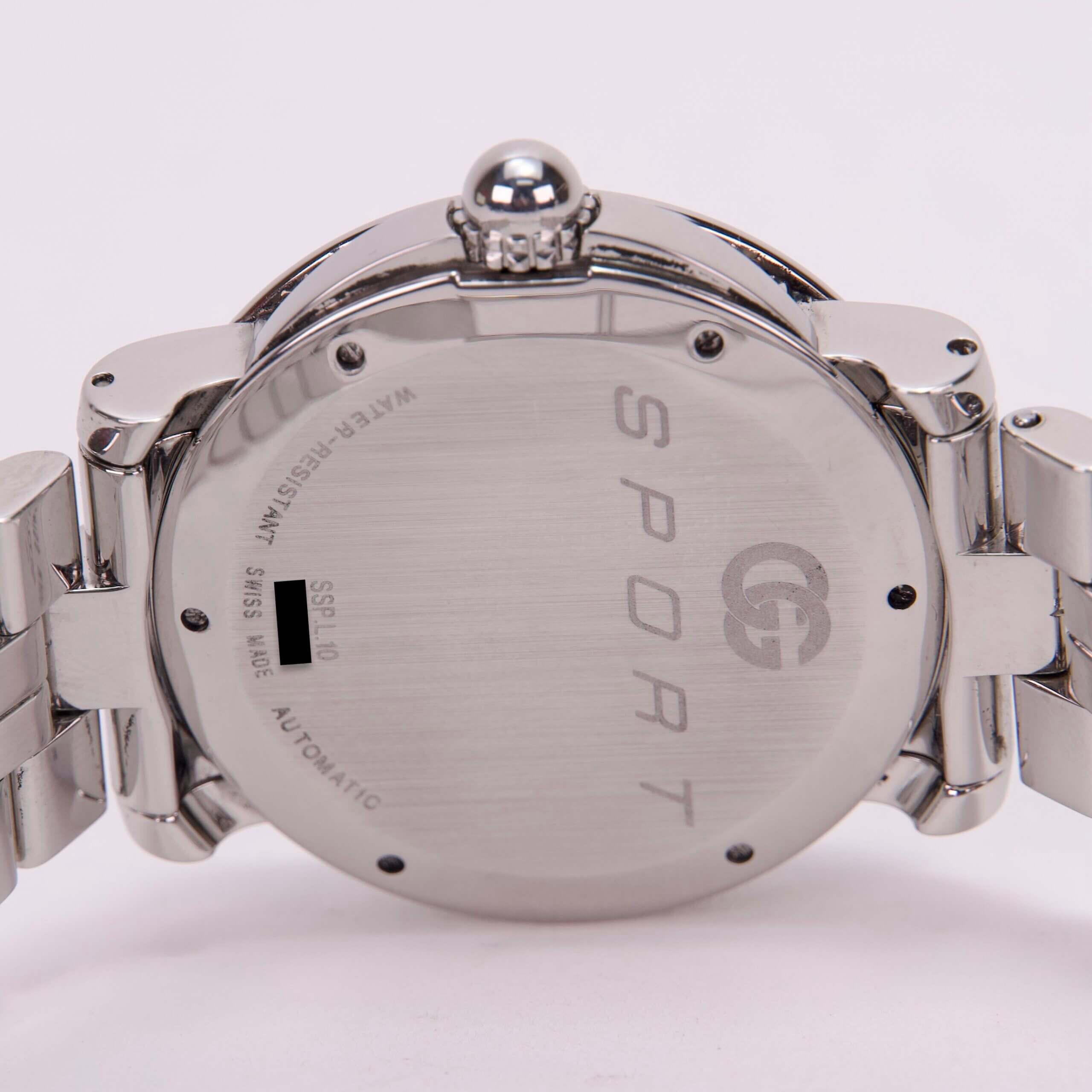 Back of silver sport wristwatch with bracelet.