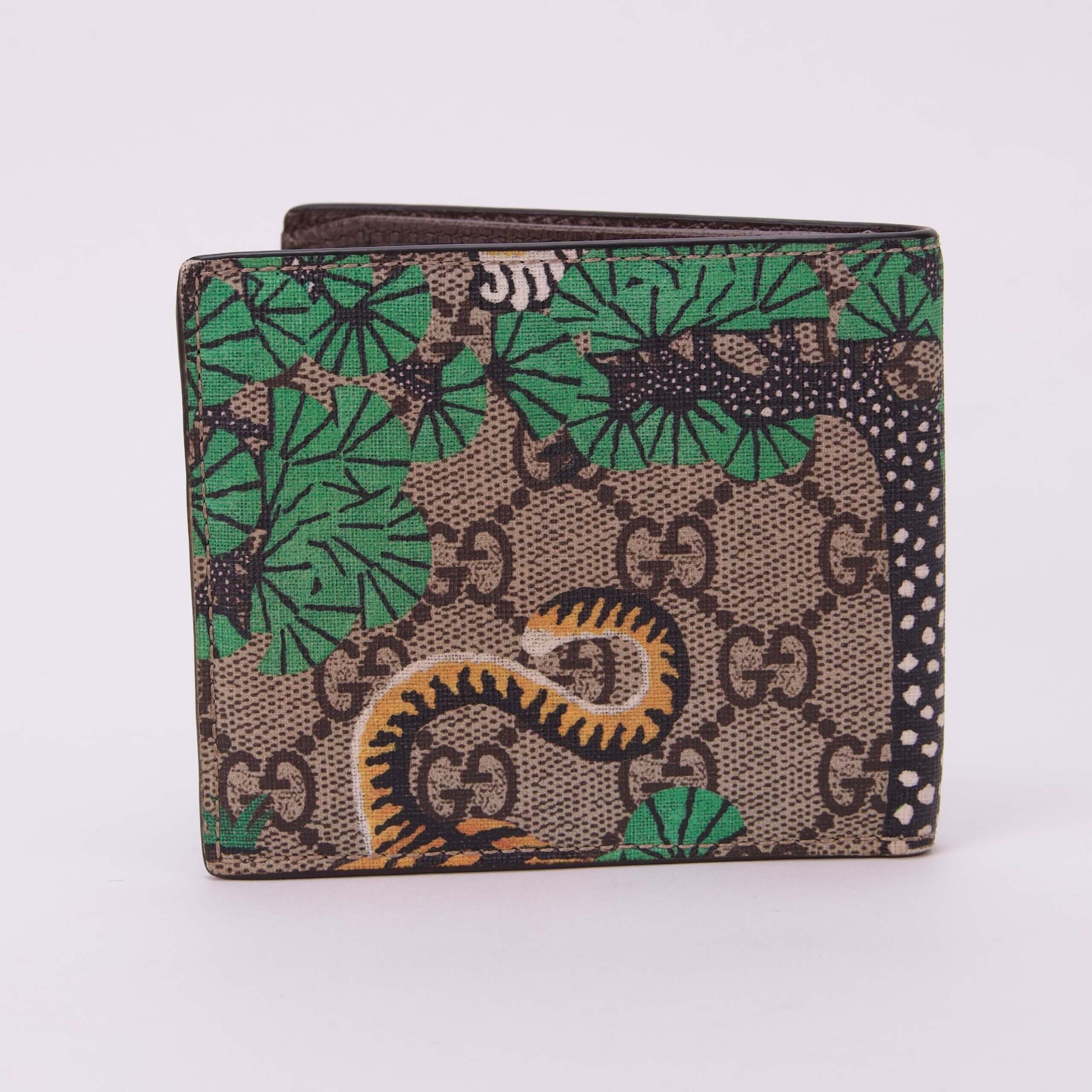 Patterned wallet with green and beige design.