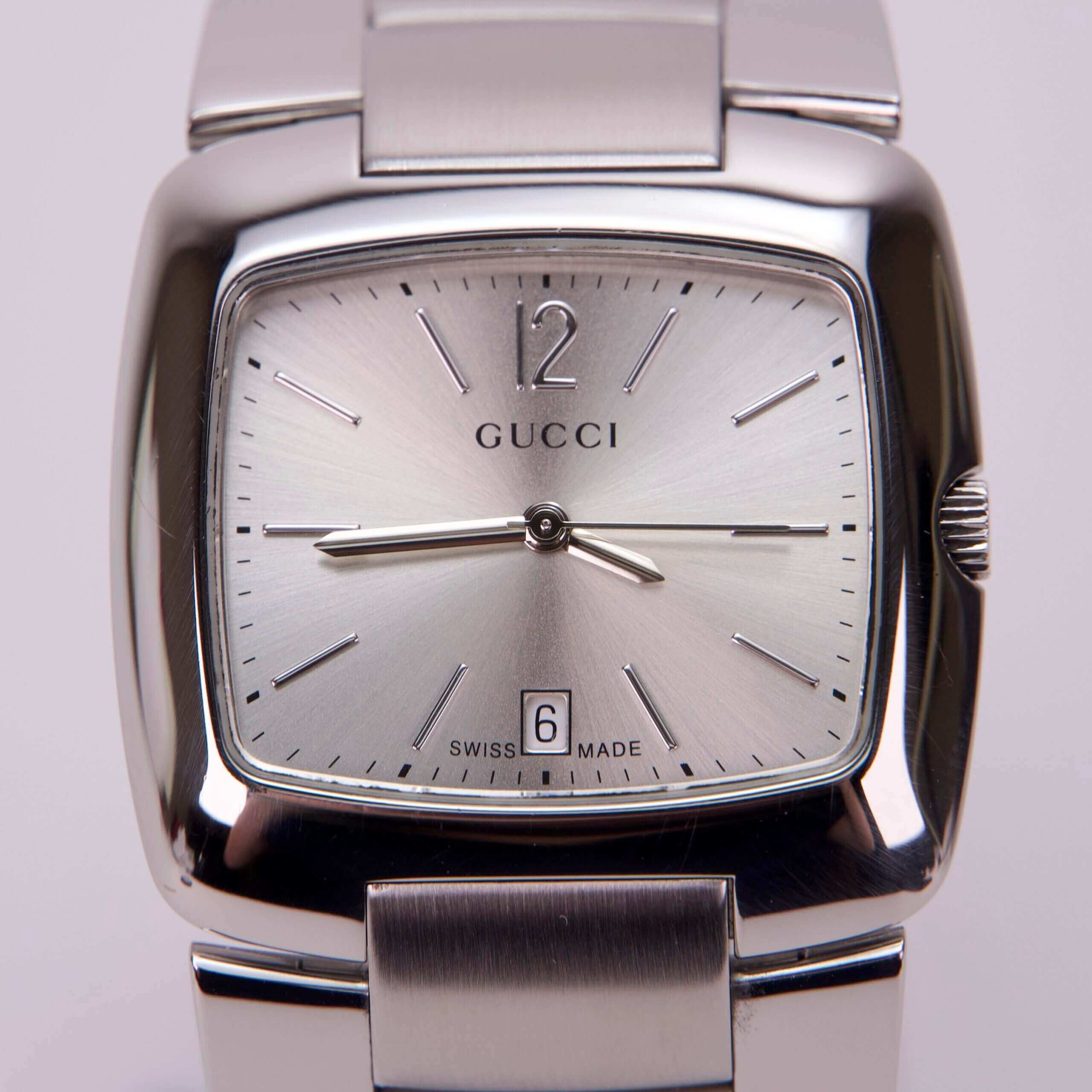 Silver Gucci watch with square face.