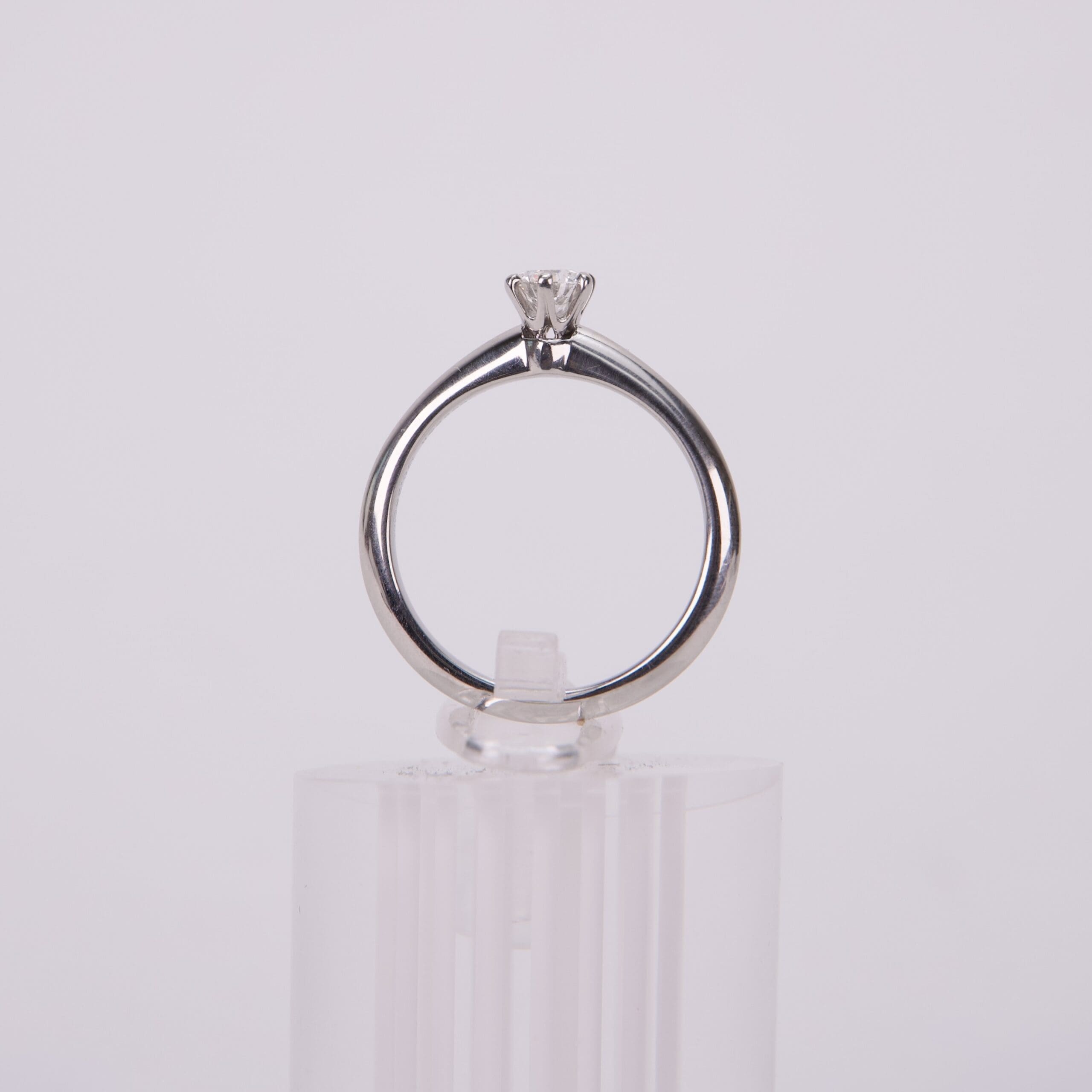 Diamond ring on clear stand.