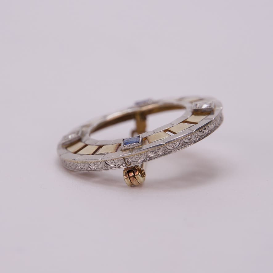 Ornate circular brooch with intricate design.
