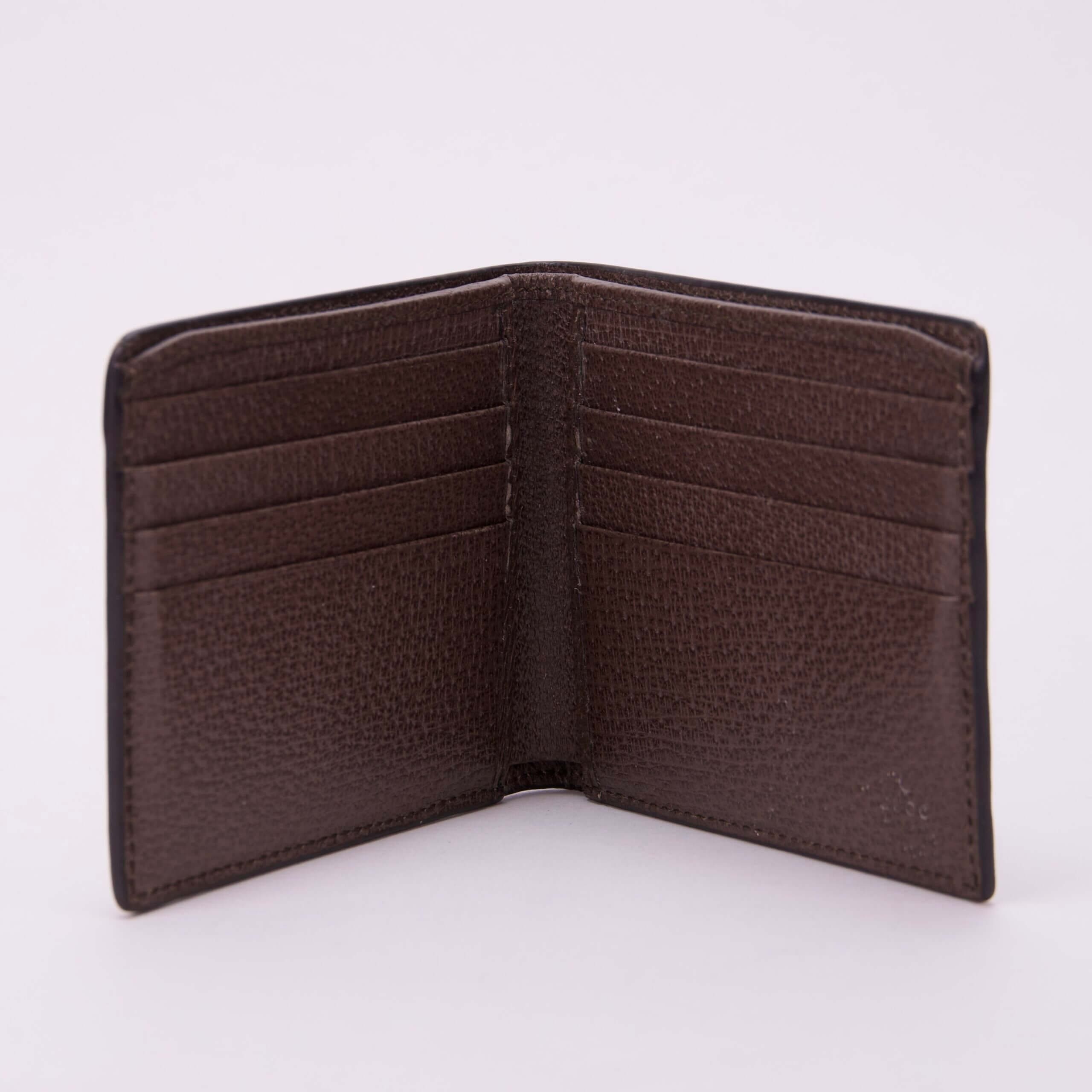 Open brown leather wallet with card slots.