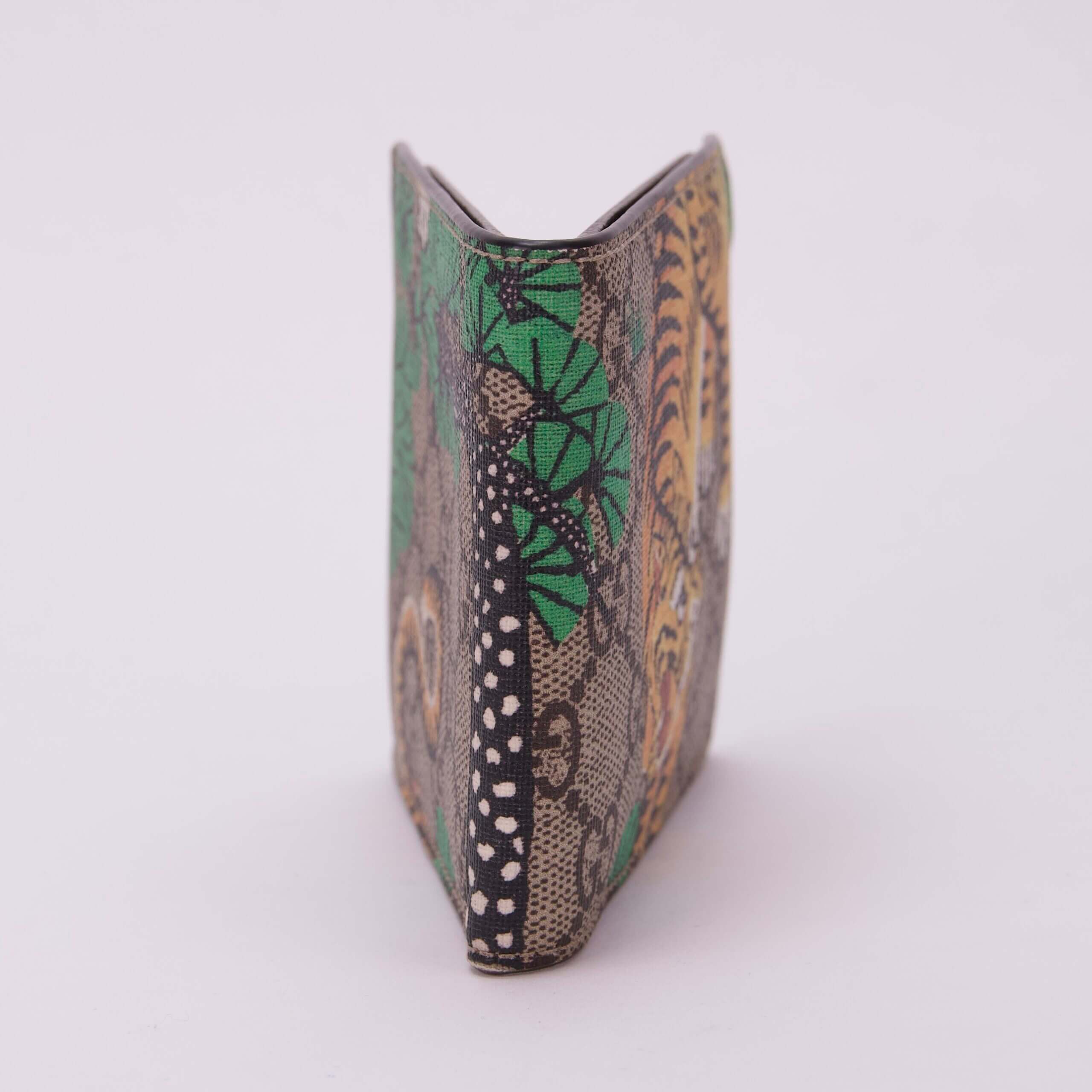 Colorful patterned wallet standing upright.